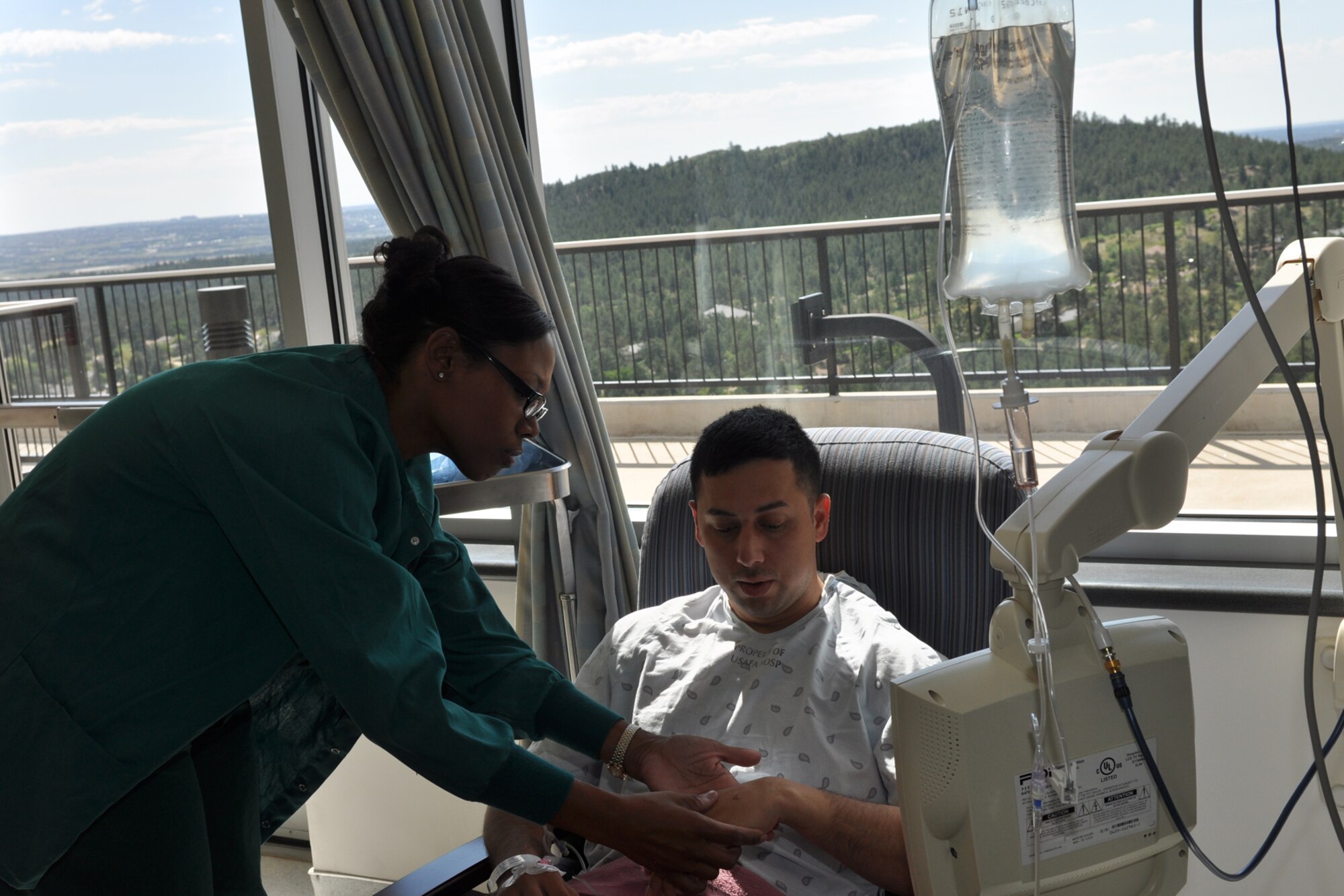 Maj. Andrea Anderson, a clinical nurse assigned to the 307th Medical Squadron from Barksdale Air Force Base, La., checks on a patient’s progress in the 10th Medical Group’s clinic at the U.S. Air Force Academy in Colorado Springs, Colo., Aug. 23, 2011. She was part of a group of 307th Bomb Wing Airmen who were at the Academy as part of their annual tour training, Aug. 13-26, 2011. (U.S. Air Force photo by Betty Stephens/Released)