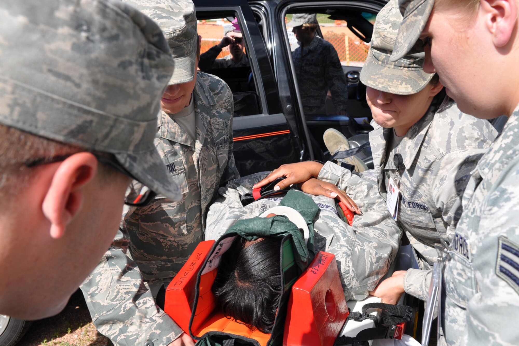 Senior Airman Cynitra Pollard, a medical technician assigned to the 307th Medical Squadron from Barksdale Air Force Base, La., lies on a stretcher during a training exercise at the U.S. Air Force Academy in Colorado Springs, Colo., Aug. 23, 2011. She was one of the passengers, during a simulated vehicle accident.  With possible spinal injuries Pollard was stabilized, removed from the vehicle, secured to a board, and moved on to a stretcher. She was part of a group of 307th Bomb Wing Airmen who were at the Academy as part of their annual tour training, Aug. 13-26, 2011. (U.S. Air Force photo by Betty Stephens/Released)