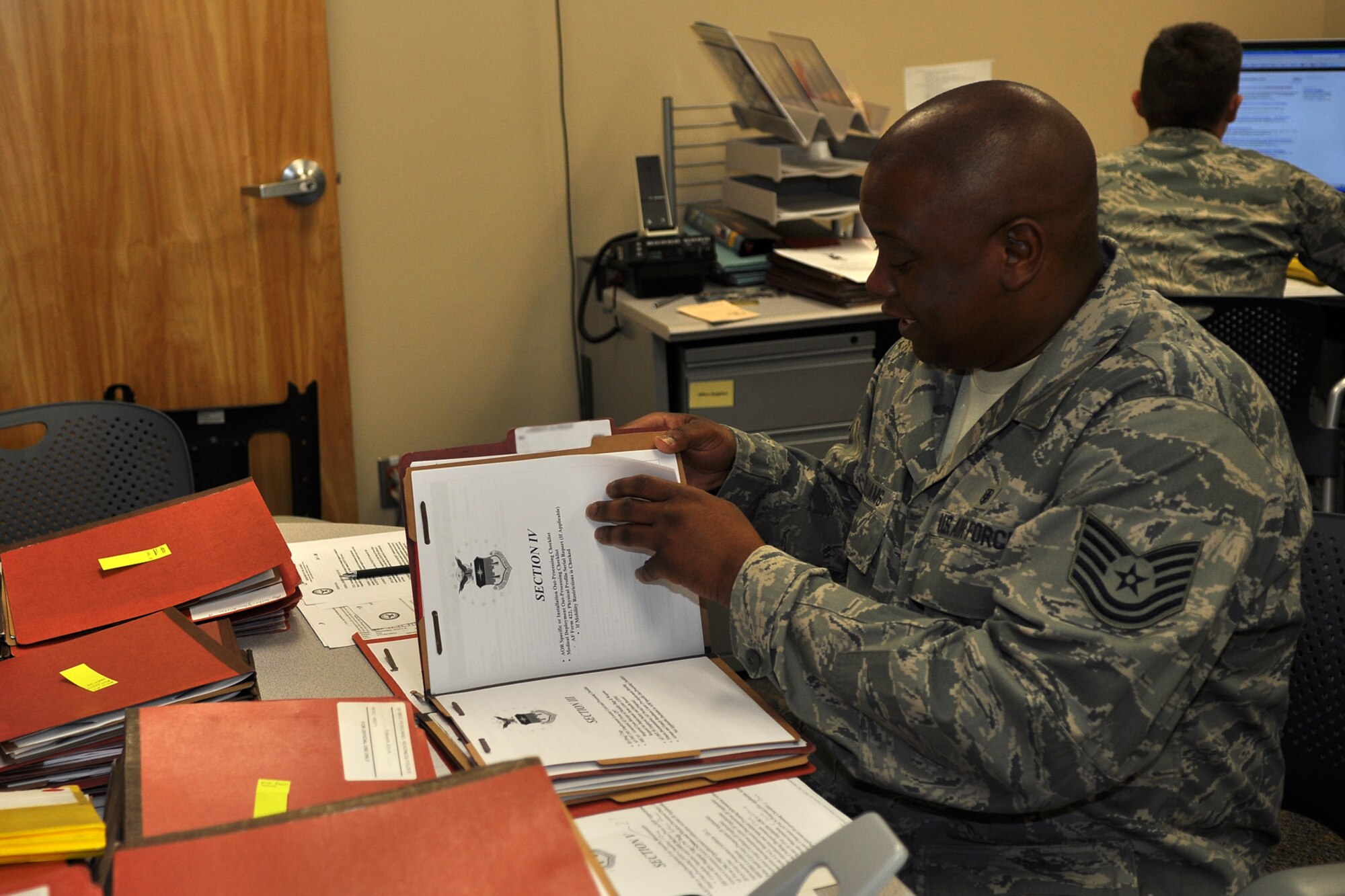Technical Sgt. Kenneth Williams, a health services attendant assigned to the 307th Medical Squadron from Barksdale Air Force Base, La., reviews record folders for the 10th Medical Group at the U.S. Air Force Academy in Colorado Springs, Colo., Aug. 22, 2011. He was helping to quality check and request members update the more than 400 training records for deployment purposes.  Williams was part of a group of 307th Bomb Wing Airmen who were at the Academy as part of their annual tour training, Aug. 13-26, 2011. (U.S. Air Force photo by Betty Stephens/Released)