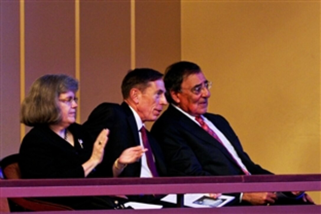 Defense Secretary Leon E. Panetta, right, and retired Army Gen. David H. Petraeus, CIA director, and his wife, Holly, attend the Washington National Cathedral's "A Call to Compassion," a commemoration of the 10th anniversary of 9/11, hosted at the Kennedy Center in Washington, D.C., Sept. 9, 2011. Panetta addressed the audience at the event.