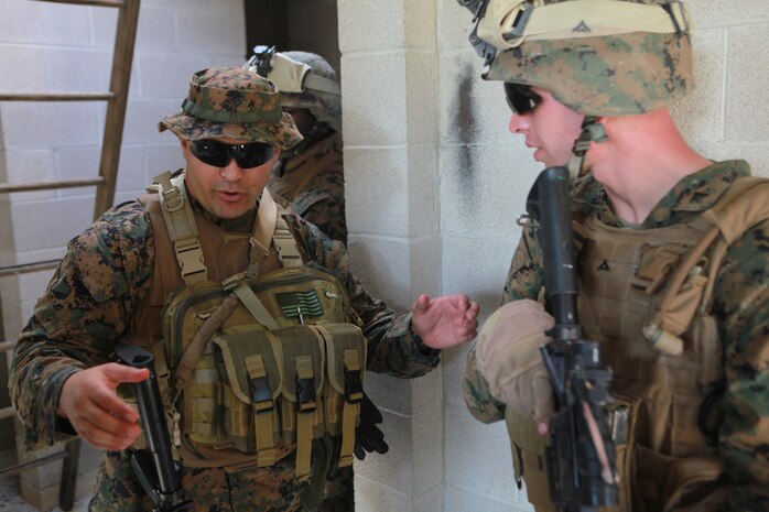 Gunnery Sgt. Joseph Alvarez, an infantry unit leader with Bravo Company, 1st Battalion, 2nd Marine Regiment, instruct a Marine during military operations in urban terrain training at the urban assault course on Fort Pickett, Va., Sept. 10, 2011. More than 900 Marines and sailors are taking part in the deployment for training exercise at Fort Pickett. The battalion will attach to the 24th Marine Expeditionary Unit a few days after the training.