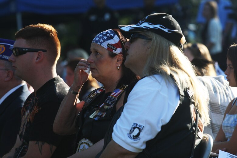 Attendees of the Patriot Day 2011 ceremony, marking the 10th anniversary of the Sept. 11, 2011 terrorist attacks, react to the proceedings at the Memorial Beam in Lejeune Memorial Gardens, Sept. 11. A decade following the al-Qaeda attacks on the World Trade Center, the Pentagon and a failed attempt in Shanksville, Pa., American citizens come together to remember and memorialize those lost on that tragic day as well as those who lost their lives in the following War on Terror.