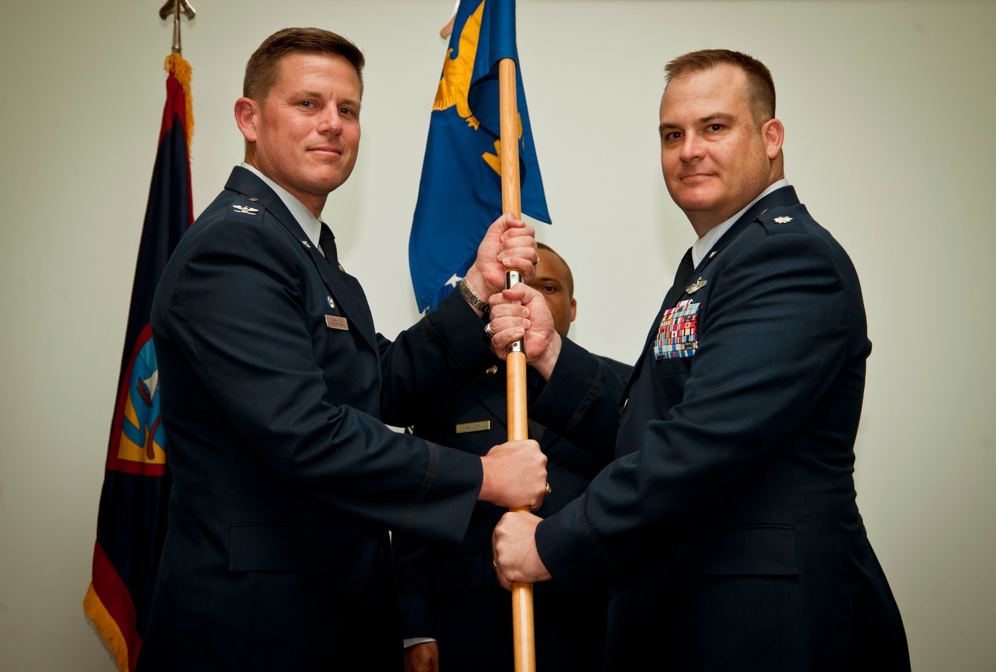 ANDERSEN AIR FORCE BASE, Guam—Col. Theodore Corallo, 36th Contingency Response Group commander, gives the guidon to Lt. Col. Michael Black, 36th Mobility Response Squadron commander, to show change in command of the 36th MRS at the Sunrise Conference Center here, Sep. 7. The passing of the guidon is a tradition used to show the change of command to troops assigned to the unit. (U.S. Air Force photo by Senior Airman Benjamin Wiseman/Released)