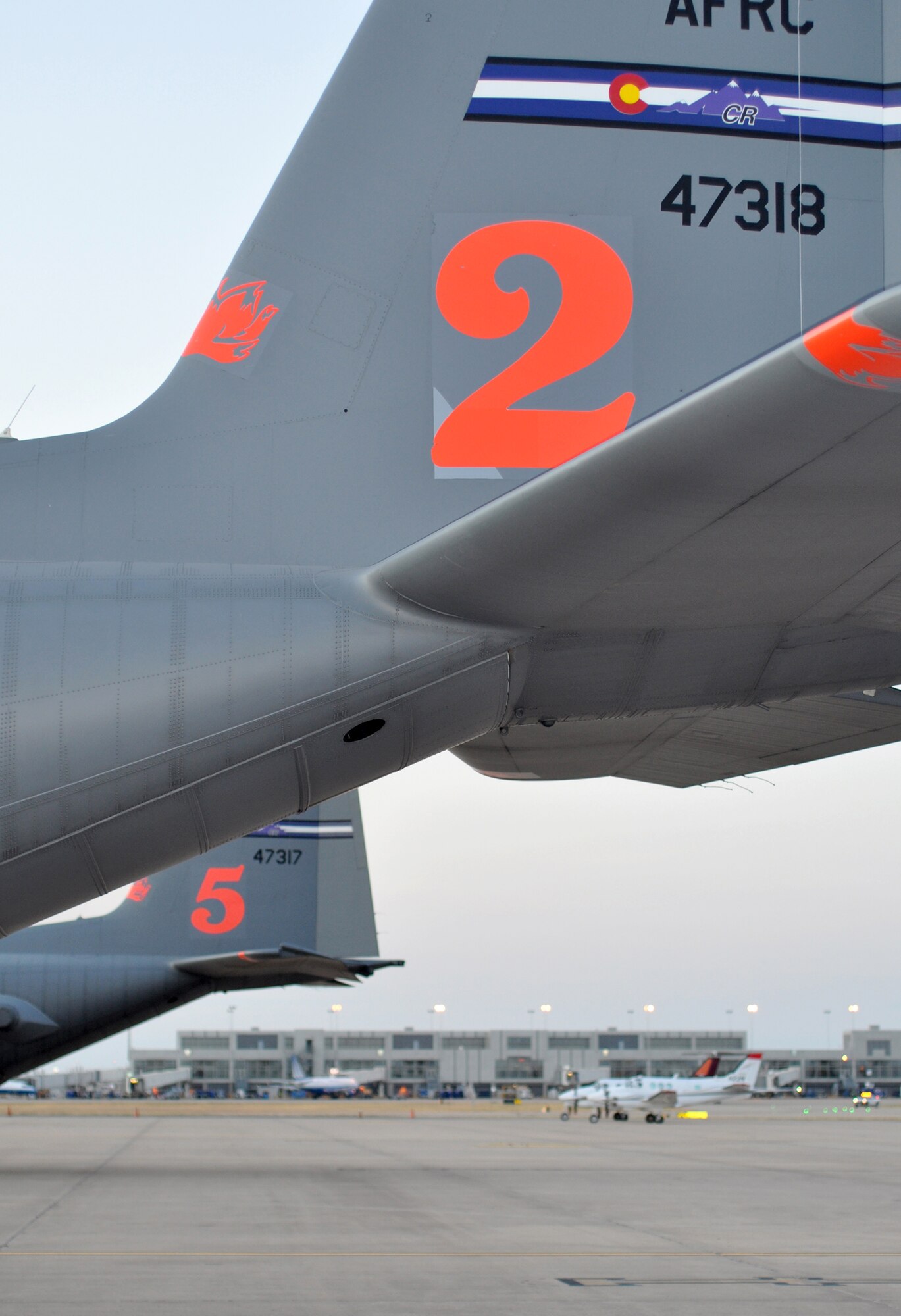 Aircraft numbers "2" and "5" from the Colorado-based 302nd Airlift Wing stand ready to support aerial firefighting operations Sept. 10 at Austin-Bergstrom International Airport in Austin, Texas. There are eight C-30 Hercules aircraft assigned to the Air Force's Modular Airborne Firefighting System, or "MAFFS" program, which allows the aircraft to be distinguished from each other for ground fire crews. Just hours before, Airmen assigned to units in Colorado and North Carolina arrived at the airport to form the 302nd Air Expeditionary Group, the Air Force's response to a U.S. Forest Service support request to aid in fighting wildfires. The 302nd AEG's mission is to provide aerial firefighting capabilities using the Modular Airborne Firefighting System, or "MAFFS" system. (U.S. Air Force photo/Staff Sgt. Stephen J. Collier)
