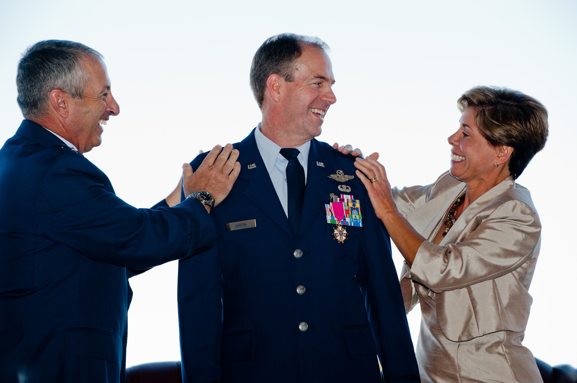 Brig. Gen. Richard L. Martin, Assistant Adjutant General - Air and Colorado Air National Guard Commander, watches his wife Roseann and Adjutant General of Colorado Maj. Gen. H. Michael Edwards attach his new rank to his dress uniform Sept. 10, 2011 Buckley Air Force Base, CO. (U.S. Air Force photo/Master Sgt. John Nimmo, Sr.) (RELEASED)