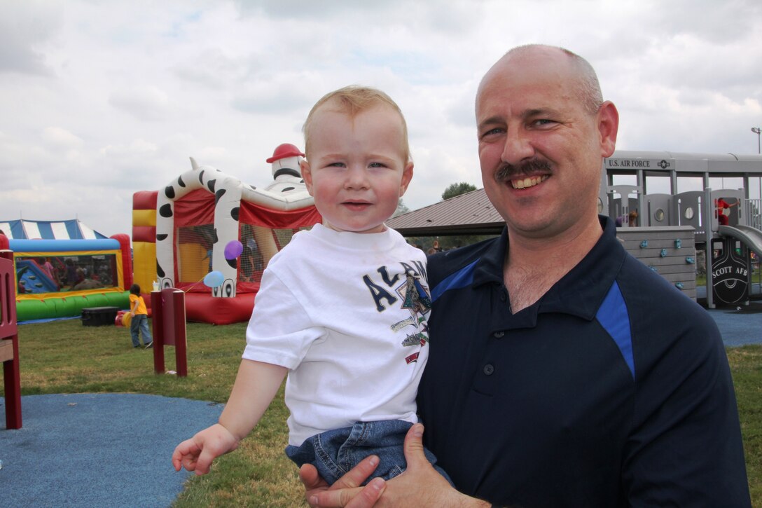 Staff Sgt. Russell Gunn and his son, Tommy, took in all the sights and sounds of the annual 932nd Wing Picnic.  Hundreds of 932nd AW members enjoyed games, contests, face-painting and other activities held during the September UTA. (U.S. Air Force photo/Tech.l Sgt. Dan Oliver)