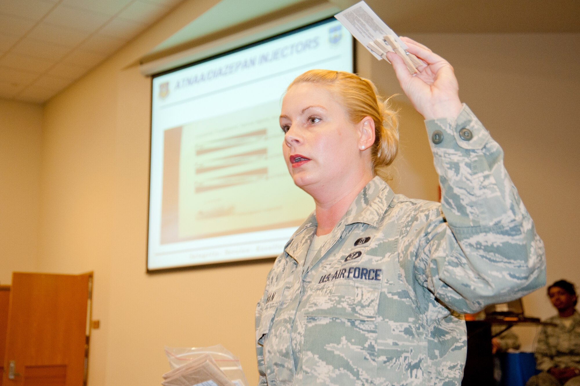 Senior Airman Marie Zieman, 403rd Wing emergency management apprentice, briefs wing Operational Readiness Inspection participants on the contents of their “war wallets,” which contains items such as simulated auto injectors. Safety, legal and emergency management issues were addressed to update ORI participants on “need-to-know” information for the January 2012 inspection. (U.S. Air Force photo/Tech. Sgt. Ryan Labadens))