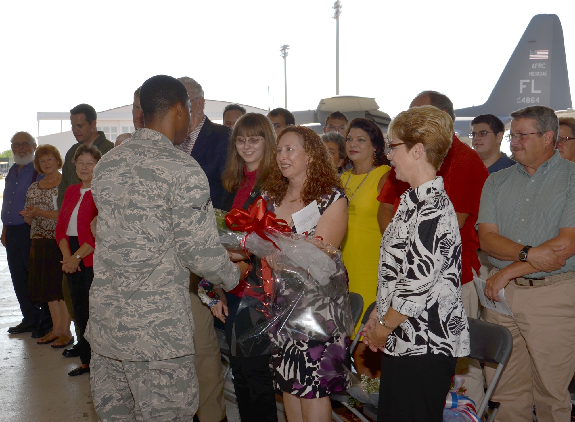 PATRICK AIR FORCE BASE, Fla. - Mrs. Carol Macrander, wife of the new 920th Rescue Wing Commander, Col. Jeffrey L. Macrander, accepts a boquet as their daughter looks on, as the Air Force Reserve Wing's new first lady during a change-of-command ceremony Sept. 11, 2011. Colonel Macrander replaced Robert L. Dunn. (U.S. Air Force photo/SSgt. Anna-Marie Wyant).