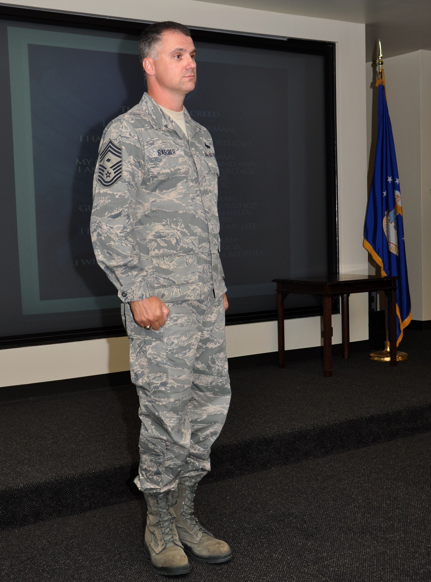 Chief Master Sgt. Mark E. Barber prepares to lead Airmen and guest of the 315th Airlift Wing at Joint Base Charleston, S.C.in singing the Air Force Song during the induction ceremony Sept. 10, 2011 for the wing's newest noncommissioned officers and senior noncommissioned officers. Chief Barber is the 315th Aircraft Maintenance Squadron first sergeant. (U.S. Air Force photo\Staff Sgt. Shane Ellis)