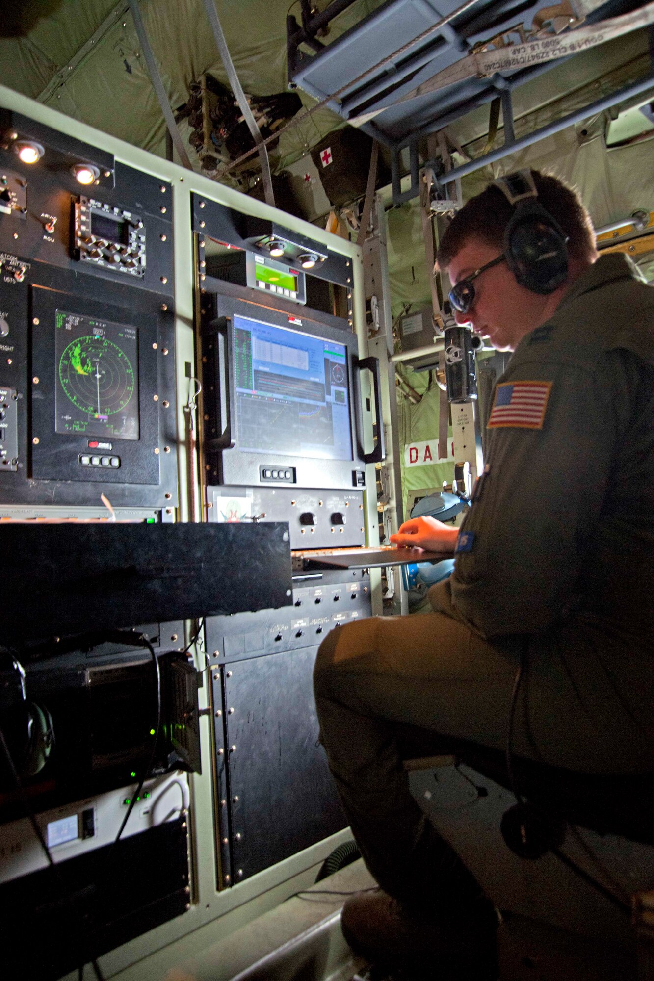 Capt. Chris Dyke, 53rd Weather Reconnaissance weather officer, analyzes data collected in Tropical Storm Nate from a released dropsonde, The storm was located off the west coast of Mexico, Sept. 9, 2011.  Based out of Keesler Air Force Base, Miss., these 403rd Wing Reservists collect data for the National Hurricane Center in Miami, enabling forecasters there to increase forecasting accuracy by 30 percent.