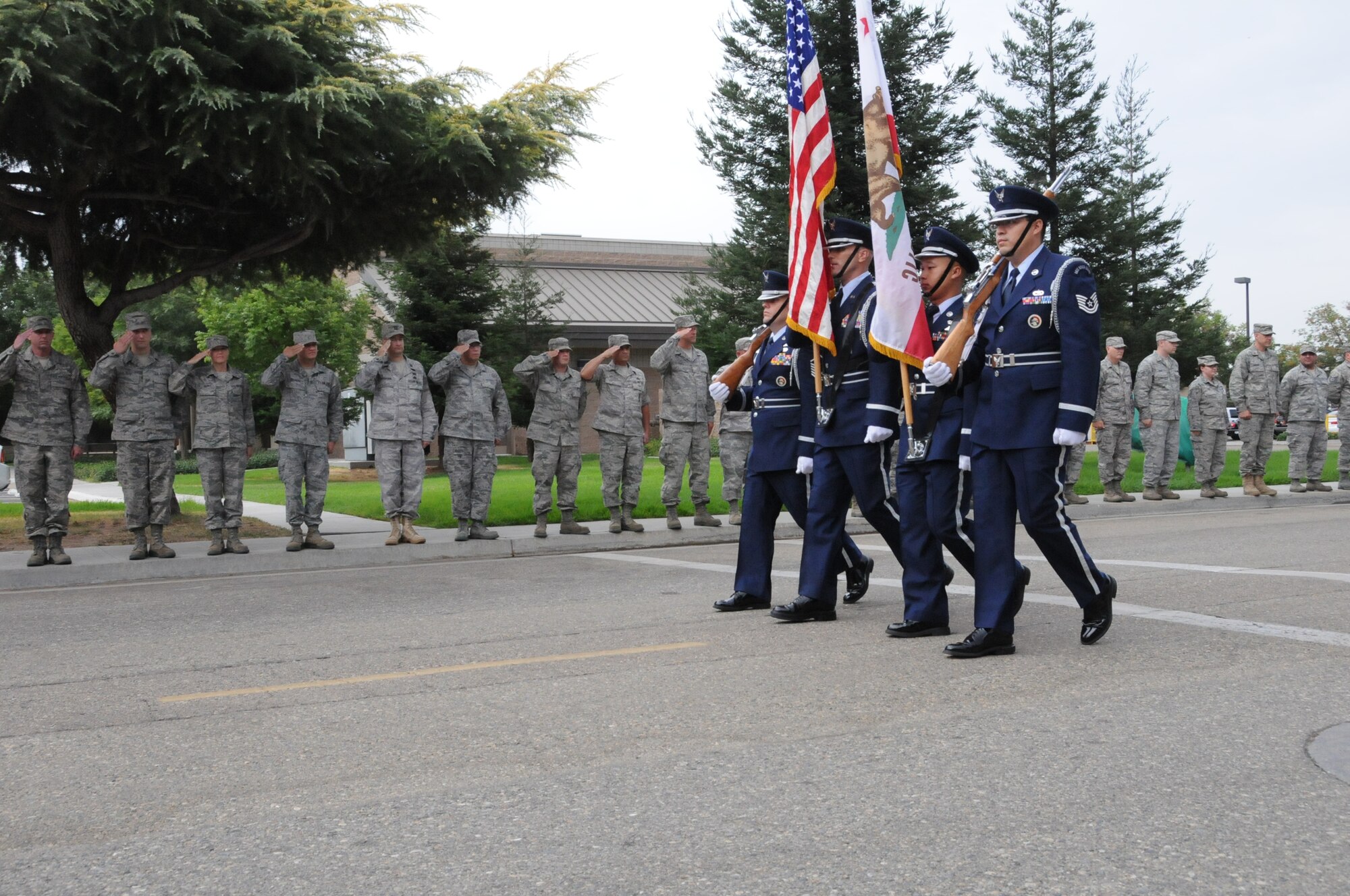 The 144 Fighter Wing Honor Guard passes by members of the 144th Fighter Wing, California Air National Guard, Fresno, Calif., pausing to honor those who served, perished and paid the ultimate sacrifice during a remembrance ceremony on Sept. 11, 2011. The ceremony included time to ponder our great losses, an invocation from the base chaplain, a 21 gun salute and a display of military and civilian emergency vehicles .(U.S.Air Force photo by MSgt David Loeffler)