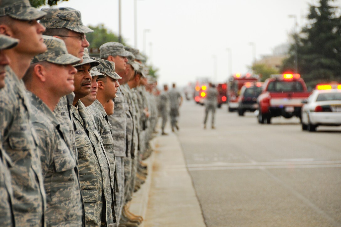 Members of the 144 Fighter Wing, California Air National Guard, Fresno Calif.,  pause to honor those who served, perished and paid the ultimate sacrifice during a ceremony Sept. 11, 2011. The ceremony included time to ponder our great losses, an invocation from the base chaplain, a 21 gun salute and a display of military and civilian emergency vehicles. (U.S. Air Force photo by Tech. Sgt Robin D. Meredith)