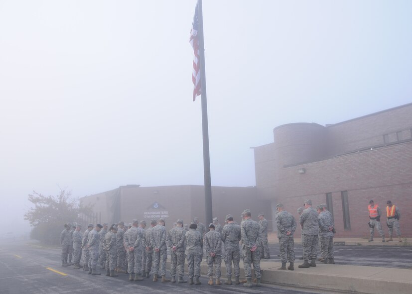 Members of the 131st Bomb Wing, Missouri Air National Guard, at Lambert Saint-Louis ANGB, attend an early morning 9-11 rememberance ceremony led by Chaplain 1Lt. Lance Qualmann.  A moment of silence was held at 7:46am central time to coincide with when the first World Trade Center Tower was hit by terrorists in a hijacked aircraft 10 years ago. (Photo by Master Sgt. Mary-Dale Amison)