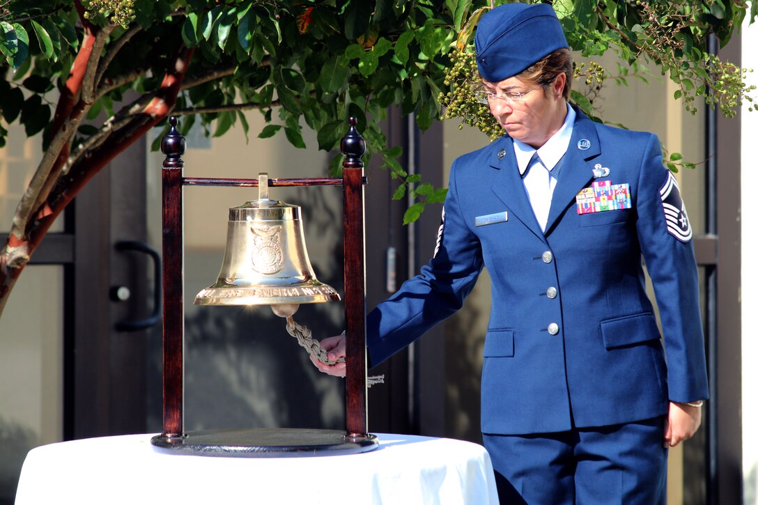 Senior Master Sgt. Rhonda McMichael rings a bell at 7:46 a.m. Central Standard Time Sept. 11, 2011, in honor of the men, women and children who perished when American Airlines Flight 11 crashed into the North Tower of the World Trade Center in New York City Sept. 11, 2001. The Continental U.S. North American Aerospace Defense Command Region-1st Air Force (Air Forces Northern) held a ceremony to honor the memory of those who died during the worst terrorist attack on American soil. (U.S. Air Force photo by Angela Pope)