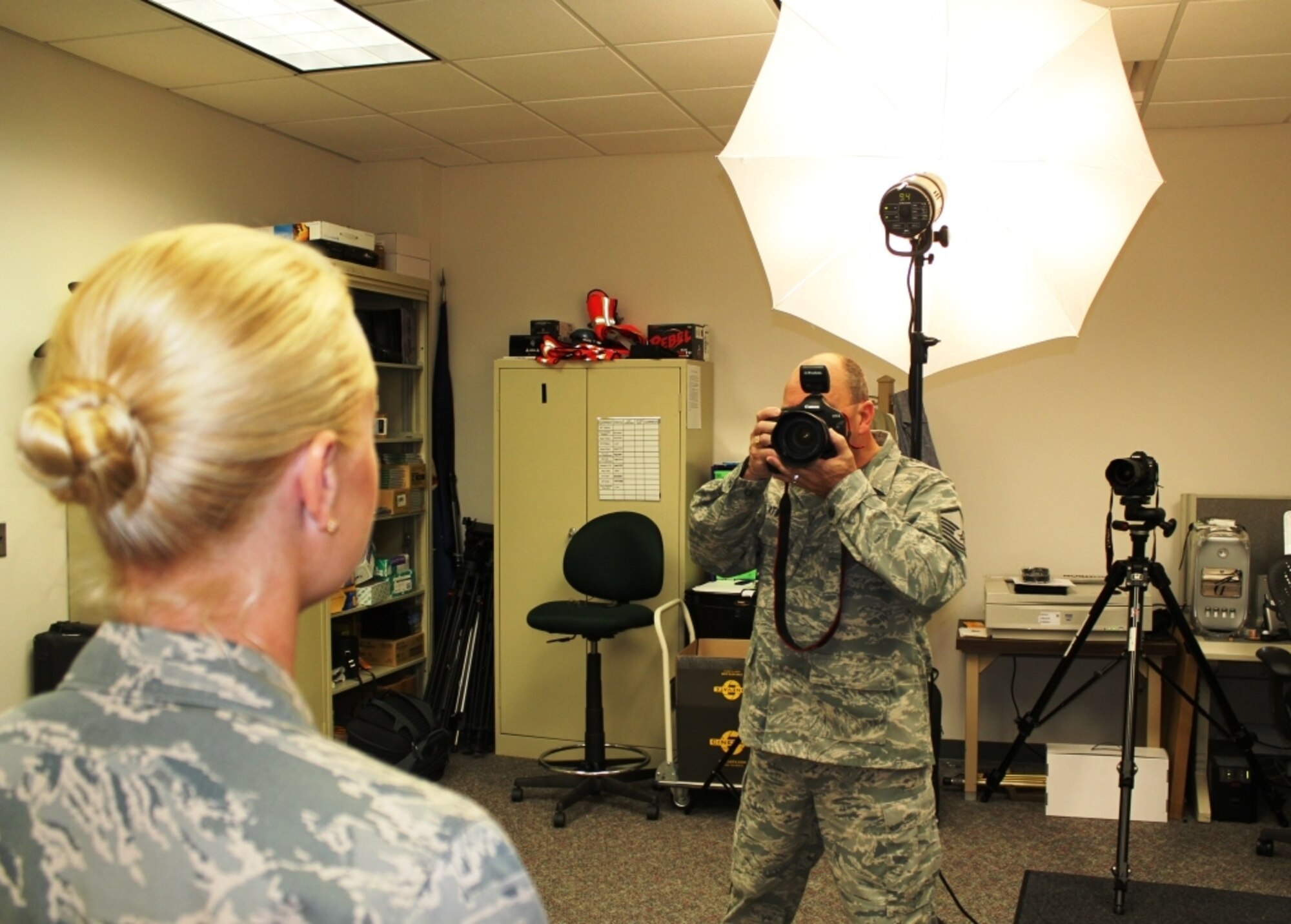 Master Sgt. Terry Atwell takes a photograph of a member of the 127th Wing at Selfridge Air National Guard Base, Mich., Sept. 10, 2011. The photo will be used to make an identification card for the Airmen. As members of the Air National Guard, the Citizen-Airmen of the 127th Wing maintain a high degree of readiness to be able to forward deploy with little notice. (U.S. Air Force photo by TSgt. Dan Heaton)