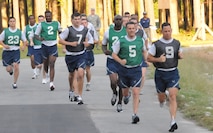 Col. Randy Ogden, wing commander (forefront left) and Col. Jim Hurley, mission support group commander, (forefront right) run neck-in-neck during their fit-to-fight test here on Sept. 11. Both commanders made excellent scores during their test. (USAF photo by SSgt. Terrica Jones, 916ARW/PA)