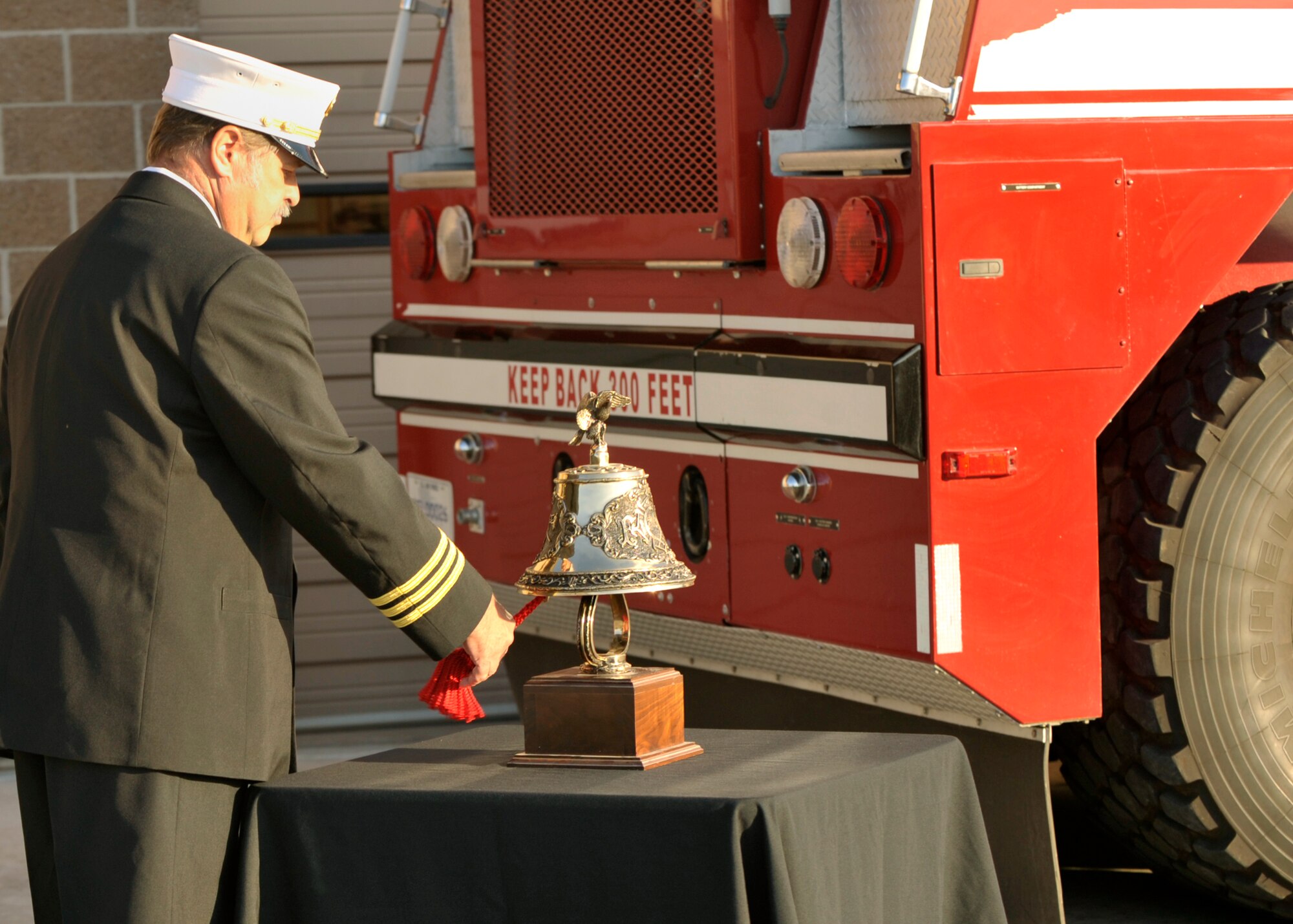 Bruce Ford, 27th Special Operations Civil Engineer Squadron assistant chief of operations , rings a bell for all the firefighters who lost their lives on September 11, 2001, at Cannon Air Force Base, N.M., Sept. 11, 2011. The ringing of the bell symbolizes the historic notification of losing a firefighter in action.  (U.S. Air Force Photo by Airman 1st Class Ericka Engblom)