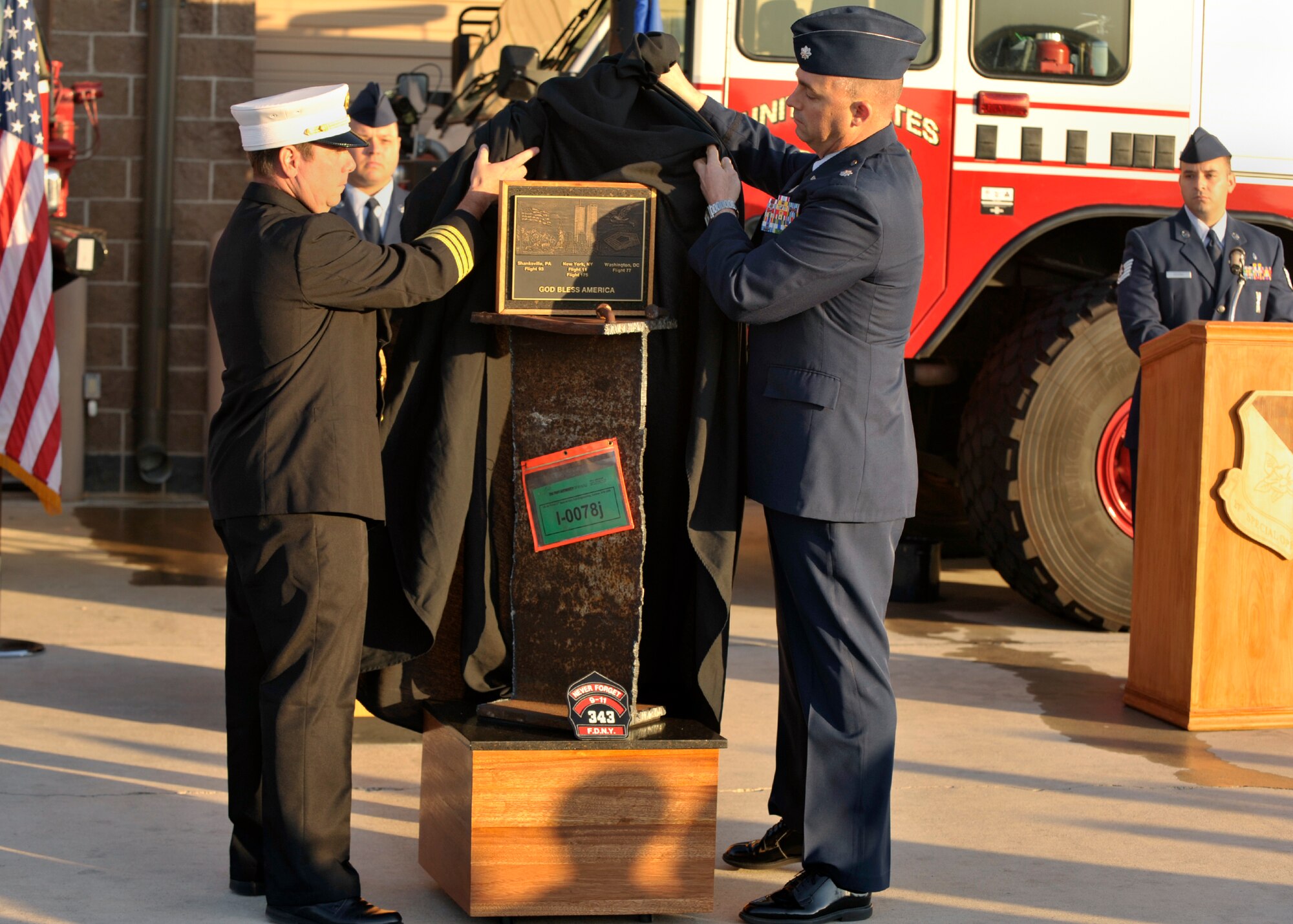 Lt. Col. Daniel Guinan, 27th Special Operations Civil Engineer Squadron commander, and Todd Miller, 27th Special Operation Civil Engineer Squadron assistant chief of operations, unveil a piece of steel from the World Trade Center during the tenth anniversary of September 11th at Cannon Air Force Base, N.M., Sept. 11, 2011. This piece of steel is the only one from the World Trade Center to be placed in New Mexico. (U.S. Air Force Photo by Airman 1st Class Ericka Engblom)