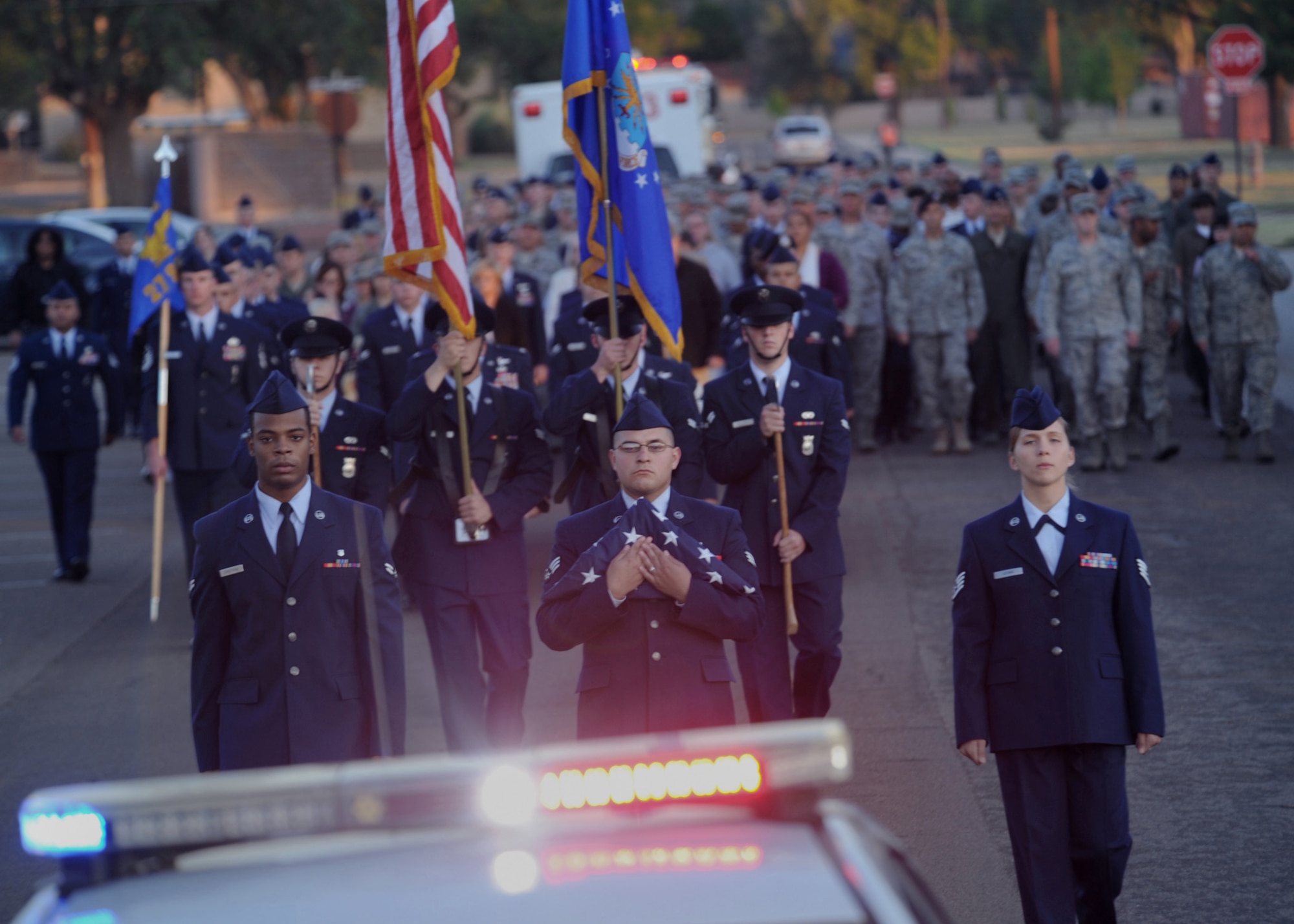 Airmen from Cannon march during the 10th anniversary of September 11th memorial at CAFB, N.M., Sept. 11, 2011.  The flag will become a permanent part of a monument honoring the victims of September 11, 2001 at the Cannon Air Force Base Fire Department.  (U.S. Air Force photo by Senior Airman James Bell)