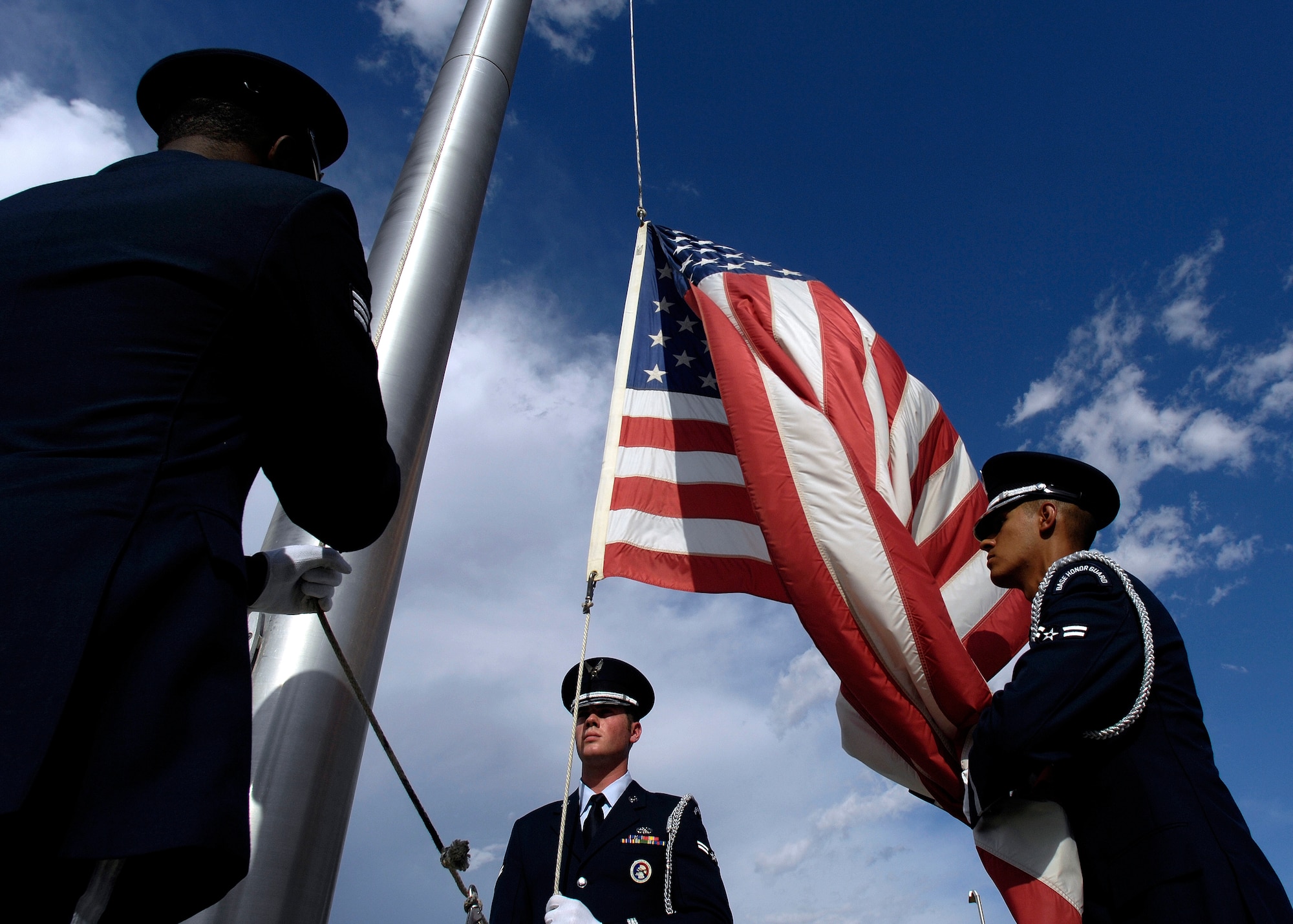 Luke Honor Guard members lower the flag during a retreat ceremony at Luke Air Force Base, Ariz., Sept. 9, 2011 in remembrance of the attacks on Sept. 11, 2001.  Airmen performed the retreat to honor the military and civlian casualties from that day.  (U.S. Air Force photo by Staff Sgt. Jason Colbert)