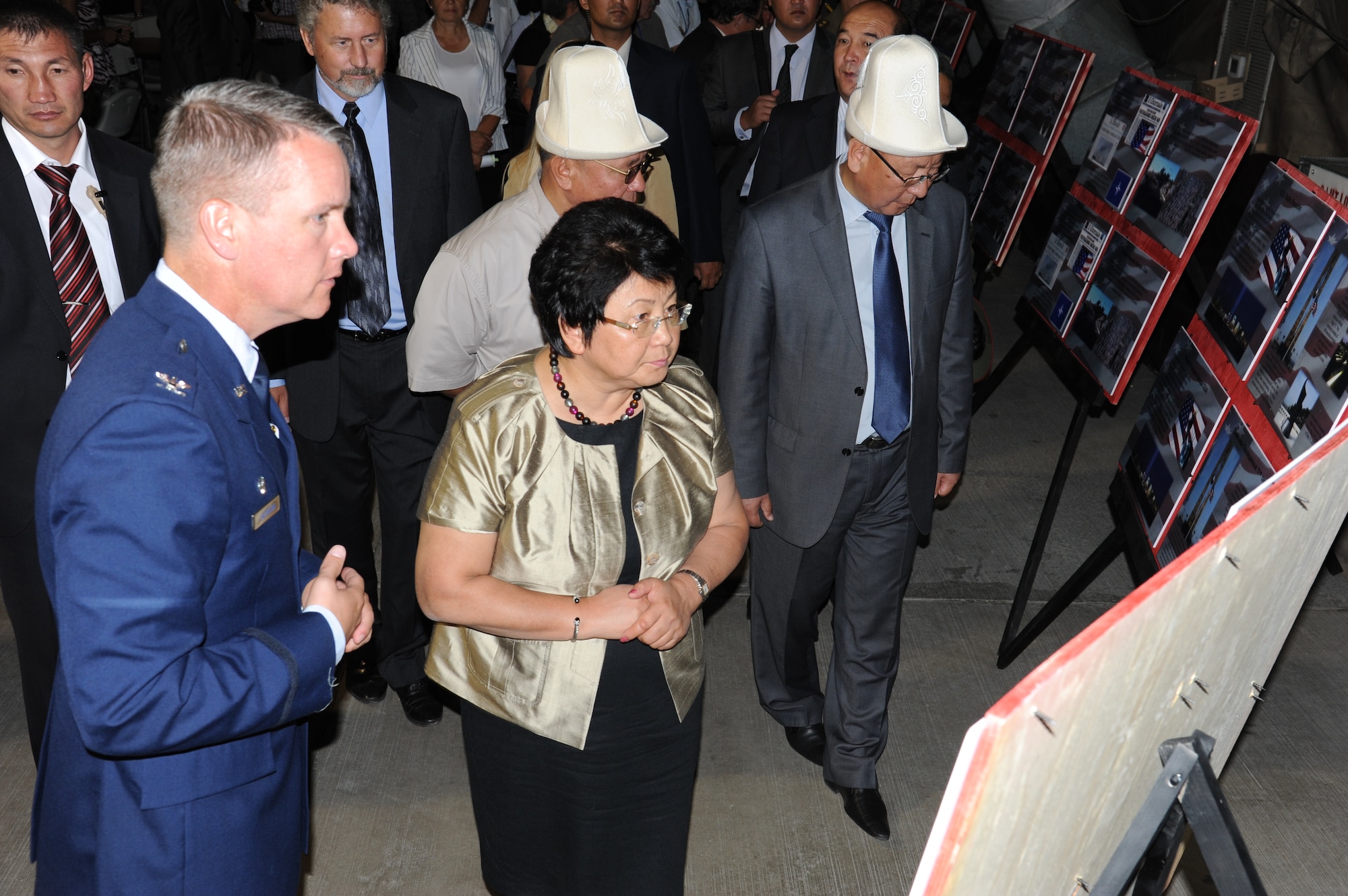 Col. James Jacobson, 376th Air Expeditionary Wing commander, shows Kyrgyz Republic President Roza Otunbayeva storyboards representing the Sept. 11, 2001 timeline of events after the 9/11 Remembrance Ceremony held at the Transit Center at Manas, Kyrgyzstan, Sept. 11. The displays were organized by the 9/11 Remembrance Ceremony committee made up of service members at the Transit Center. (U.S. Air Force photo/Tech. Sgt. Hank Hoegen)
