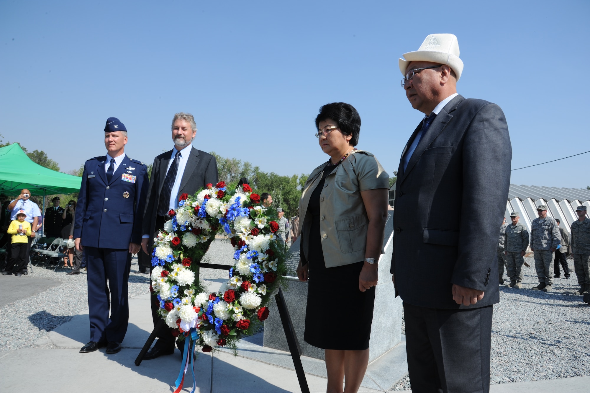 Col. James Jacobson, Larry Memmott, President Roza Otunbayeva and Emirbek Kaptagaev, present a wreath at the Pete Ganci memorial at the Transit Center at Manas, Kyrgyzstan, during the 9/11 Remembrance Ceremony Sept. 11. Distinguished visitors from 16 different countries including South Korea and France attended the ceremony. Jacobson is the 376th Air Expeditionary Wing commander and Memmott is the U.S. Embassy Charge d’Affaires. Otunbayeva  is the president of the Kyrgyz Republic and Kaptagaev is the president’s official escort.(U.S. Air Force photo/Tech. Sgt. Hank Hoegen) 