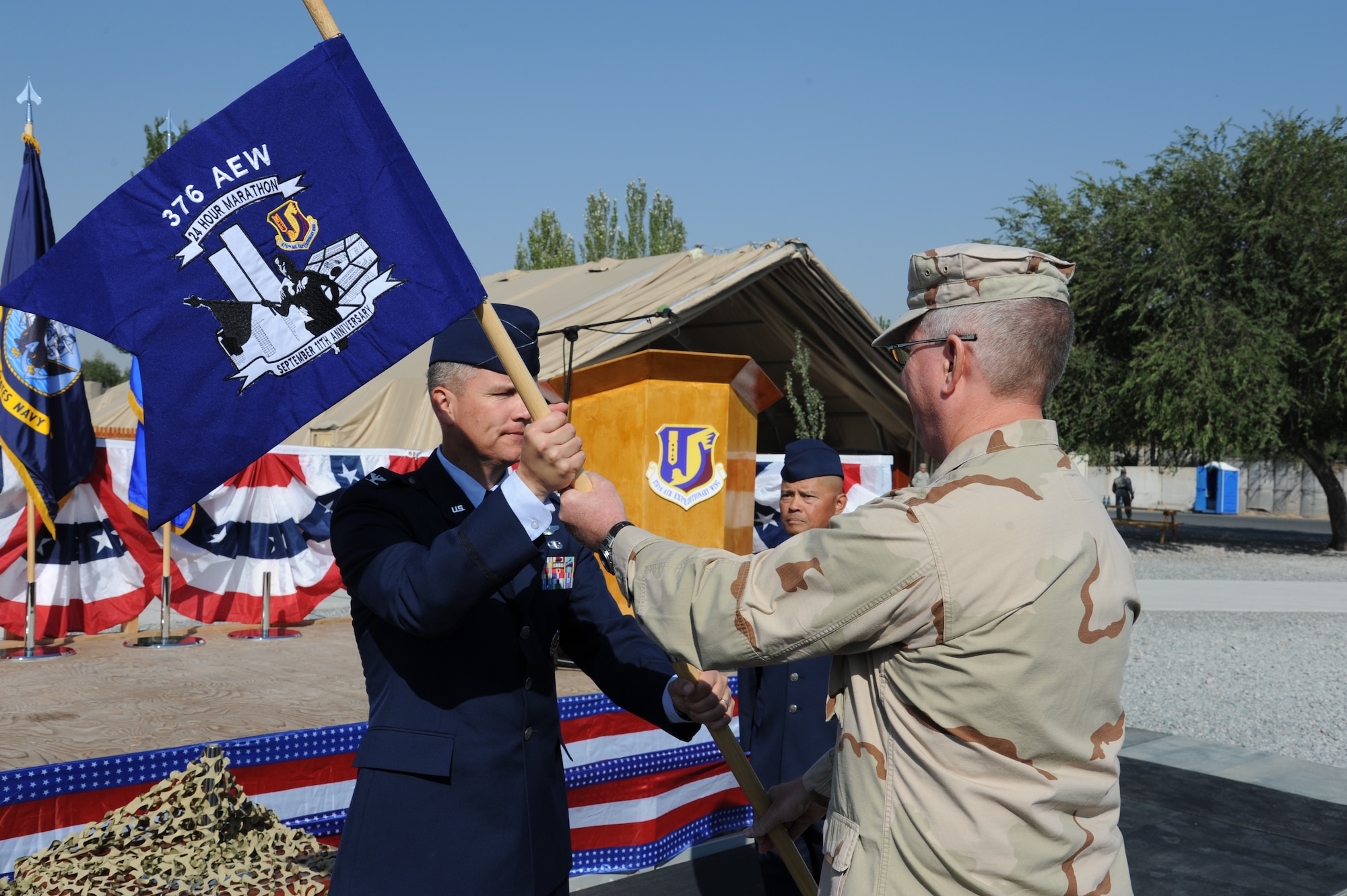 Col. James Jacobson, 376th Air Expeditionary Wing commander, receives the 9/11 Flag of Remembrance during a ceremony at the Transit Center at Manas, Kyrgyzstan, Sept. 11. The flag was continuously carried during a 24-hour memorial run honoring those who died Sept. 11, 2001. (U.S. Air Force photo/Tech. Sgt. Hank Hoegen) 