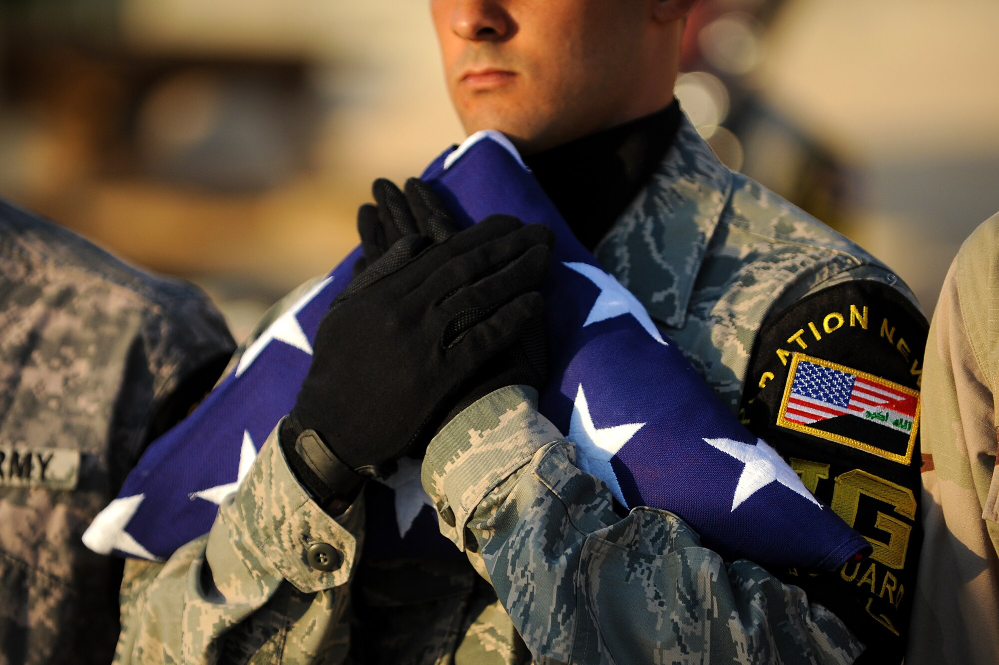 Staff Sgt. Anthony Inauen, 447th Expeditionary Communications Squadron, folds the U.S. flag to ceremonially retire the colors to Brig. Gen. Anthony Rock, 321st Air Expeditionary Wing commander, Sept. 11, 2011, in honor of the tenth anniversary of the attacks. More than 100 Soldiers, Sailors Airmen and civilians who took part in a remembrance march in full battle rattle. The two-mile march, split up into groups of 10, honored those who lost their lives during the attacks at the World Trade Center, the Pentagon and in Shanksville, Pa. (U.S. Air Force photo/Staff Sgt. Mike Meares)