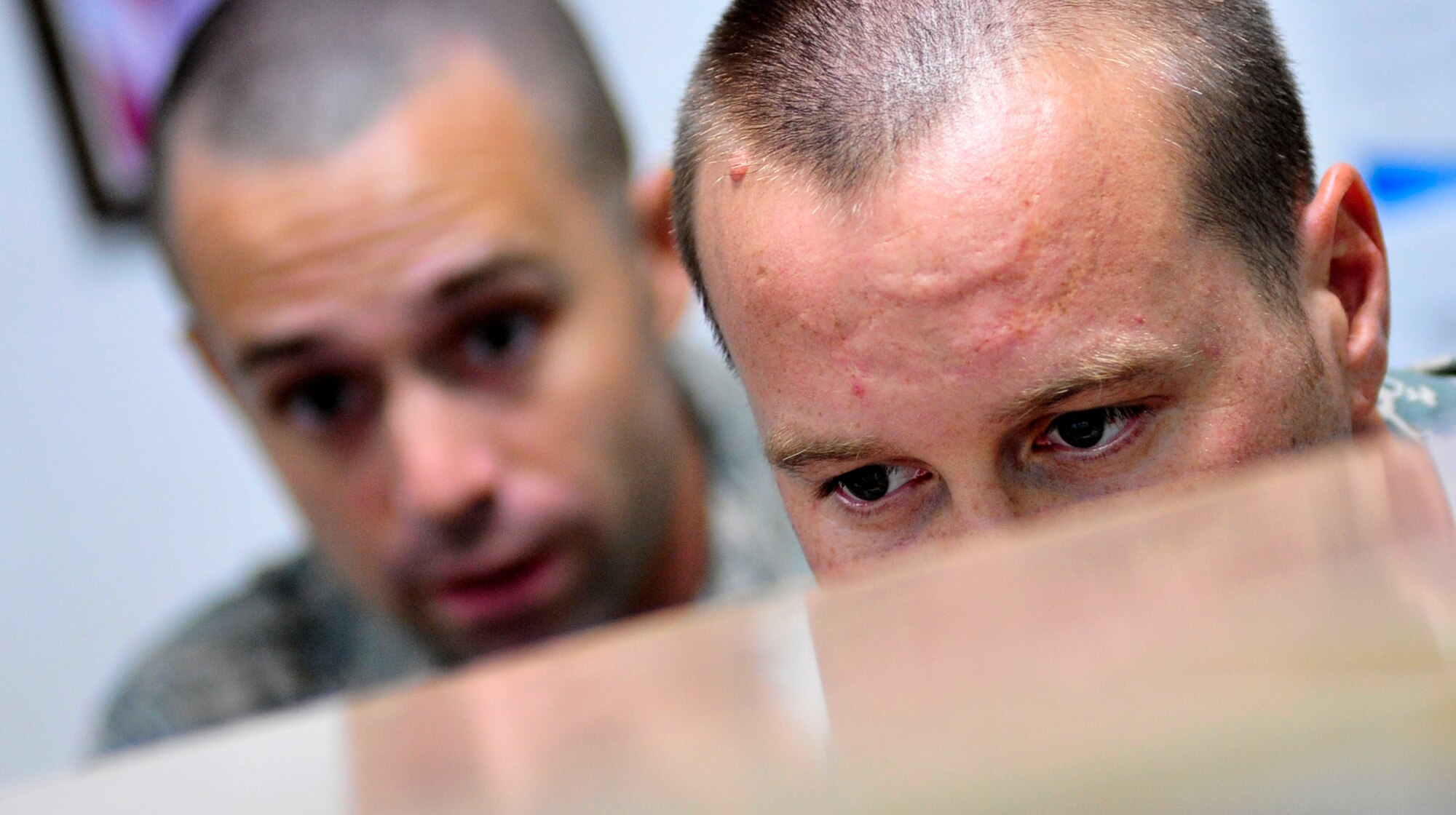 Tech. Sgt. Jeremy Fisher and Senior Airman Brandon Metz check their systems for arriving aircraft at the Ali Base passenger terminal on Aug. 25, 2011.  Sergeant Fisher is a 407th Air Expeditionary Group aerial transporter deployed from Hickam Air Force Base, Hawaii and a native of Appleton, Wisc.  Airman Metz is an aerial transporter deployed from Kadena Air Base, Japan, and his hometown is San Antonio. (U.S. Air Force photo/Master Sgt. Cecilio Ricardo)