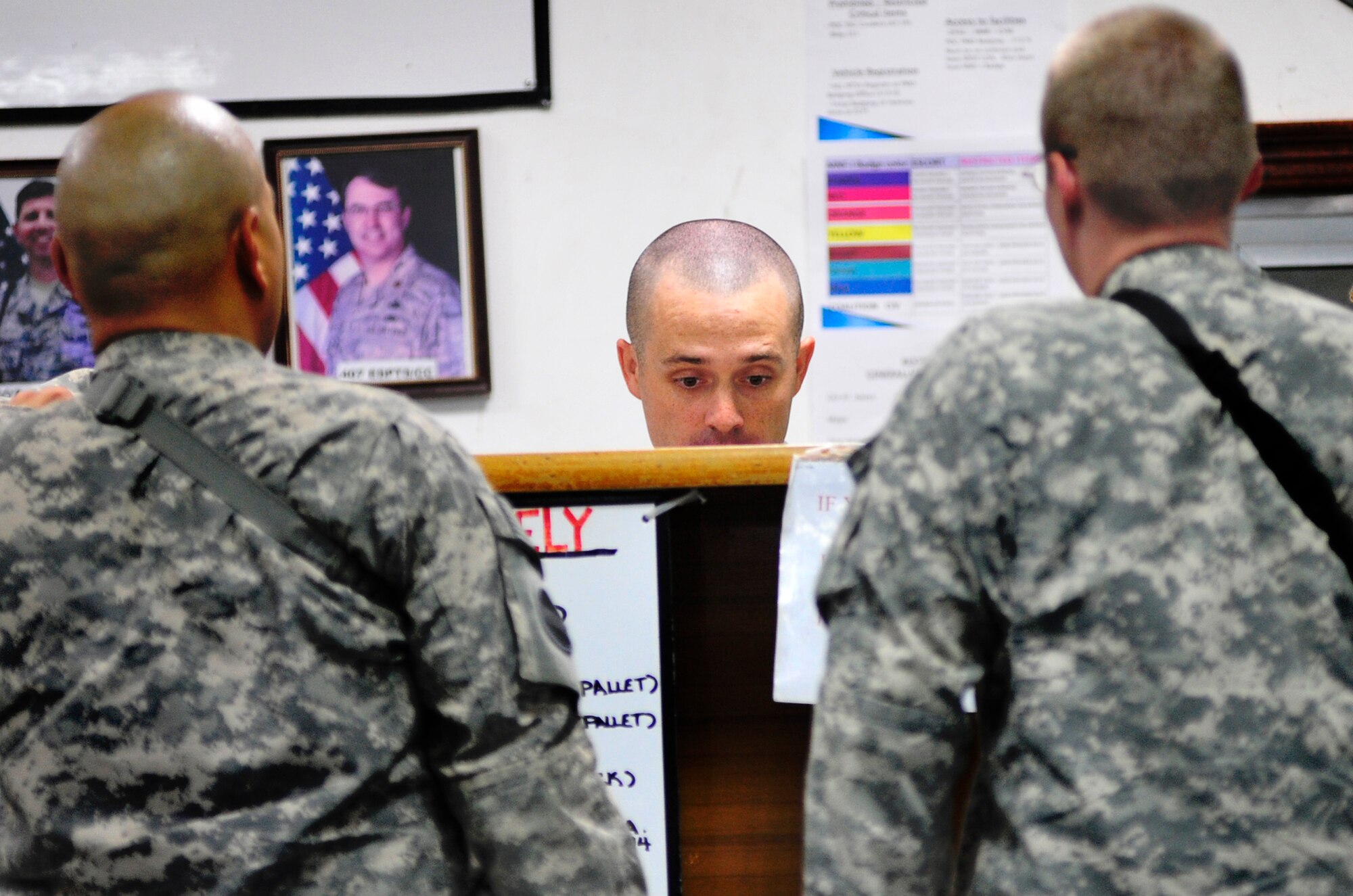 Senior Airman Brandon Metz helps customers at the passenger terminal at Ali Base, Iraq, Aug. 25, 2011. Airman Metz is stationed at Kadena Air Base, Japan, and his hometown is San Antonio. (U.S. Air Force photo/Master Sgt. Cecilio Ricardo)