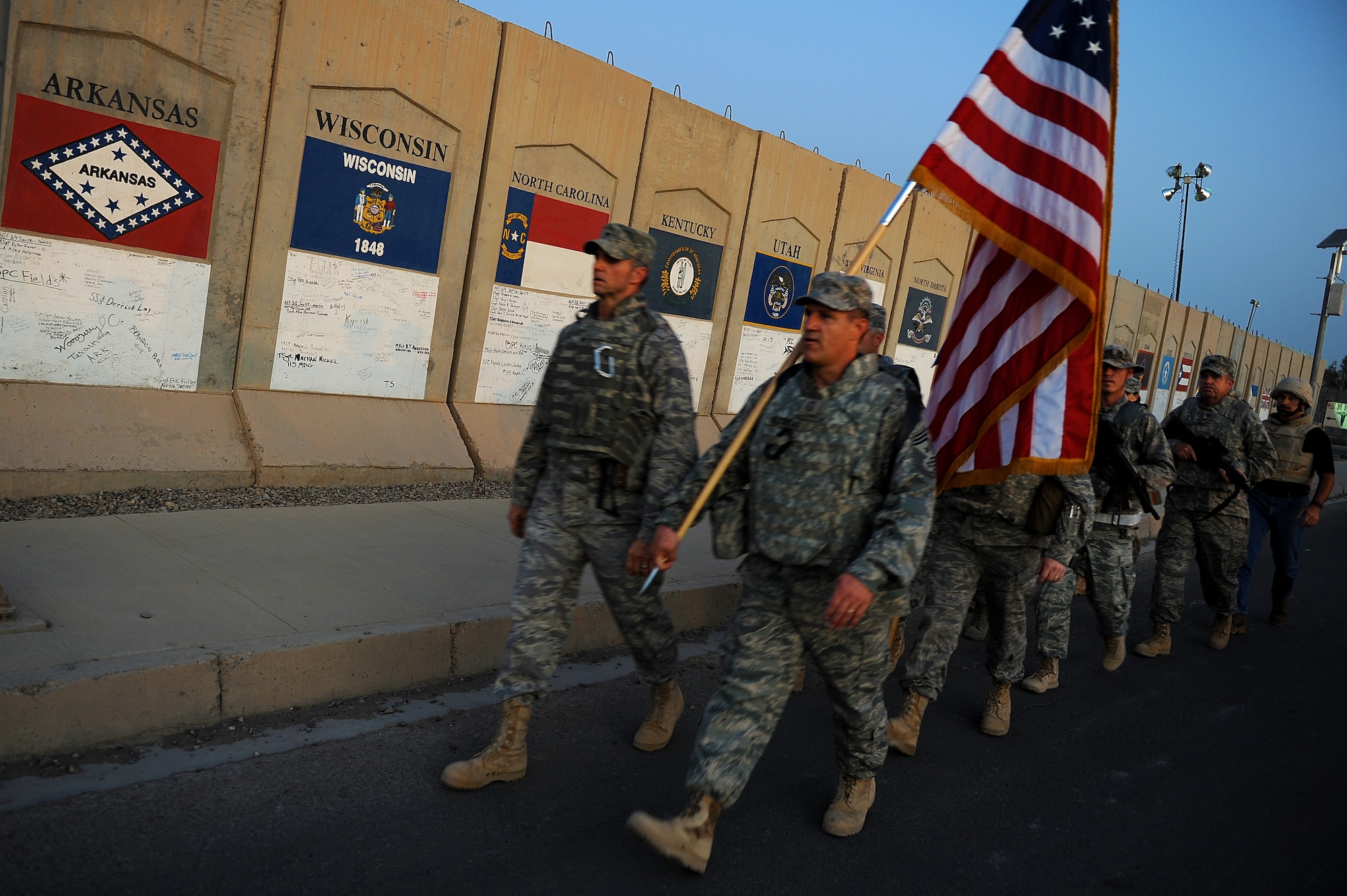 Brig. Gen. Anthony Rock and Chief Master Sgt. Gerald Delebreau, 321st Air Expeditionary Wing commander and command chief master sergeant, lead the first group of more than 100 Soldiers, Sailors Airmen and civilians who took part in a remembrance march in full battle rattle Sept. 11, 2011, in honor of the 10th anniversary of the attacks. The two-mile march honored those who lost their lives during the attacks at the World Trade Center, the Pentagon and in Shanksville, Pa. (U.S. Air Force photo/Staff Sgt. Mike Meares)
