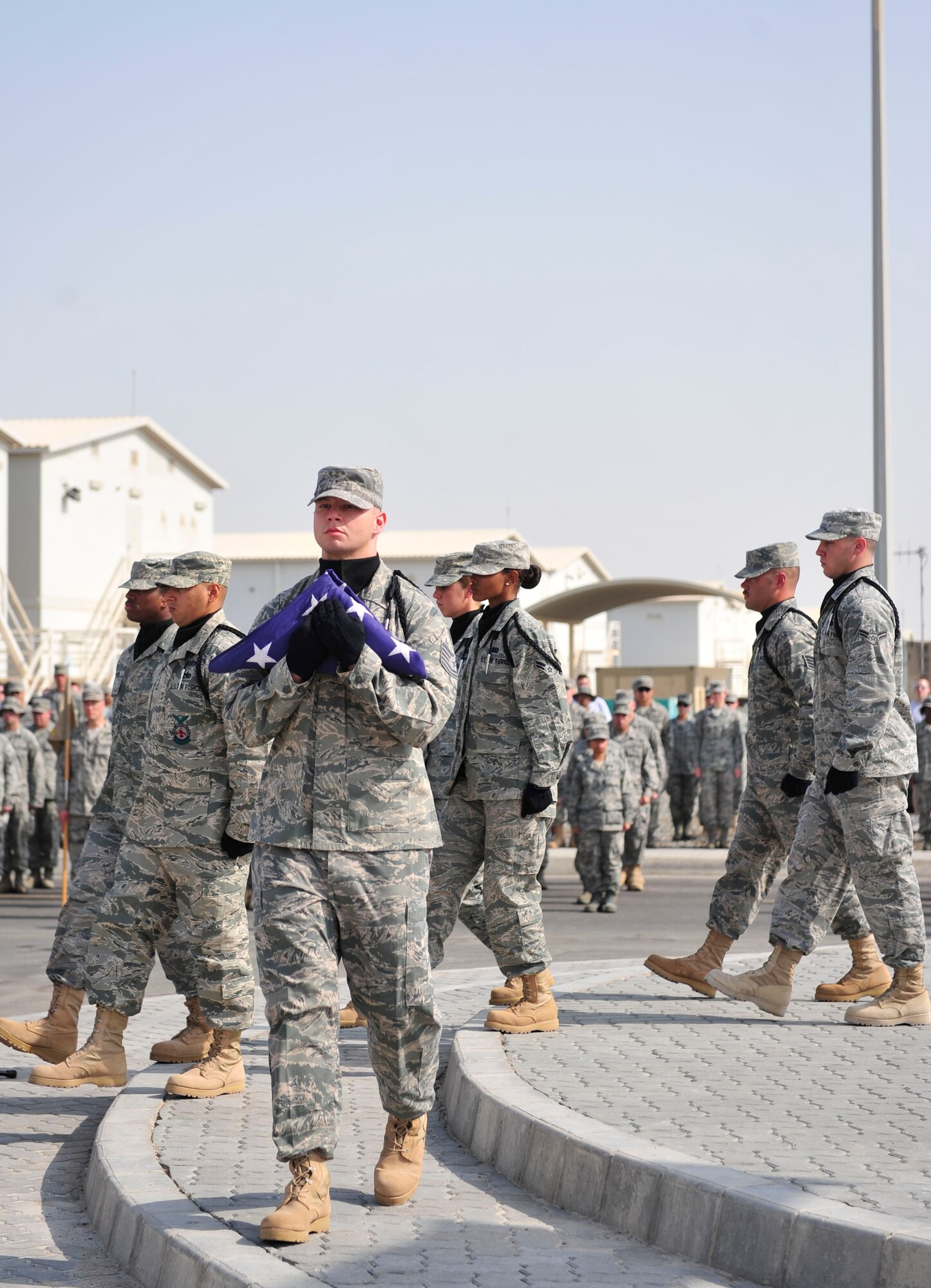 The 380th Air Expeditionary Wing Honor Guard retires the U.S. flag during a 9/11 remembrance ceremony, Sept. 11, 2011, at the 380th AEW. The Airmen of the 380th AEW and its mission partners honored the 10th anniversary of the attacks and remembered those who perished at the World Trade Center, the Pentagon, in Shanksville, Penn., and those who have given their lives in the name of freedom in the 10 years since, at a ceremony at the wing 9/11 memorial.  (U.S. Air Force photo/Tech Sgt. Patrick Mitchell)