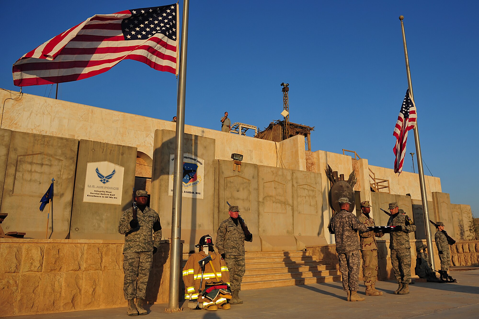 Participants of a two-mile road march, honoring the tenth anniversary of the 9/11 attacks, conduct a flag folding ceremony following the hike at Sather Air Base, Iraq, Sept. 11, 2011. More than 100 Soldiers, Sailors, Airmen and civilians donned their body armor and took part in the march as the sun rose. (U.S. Air Force photo/Tech. Sgt. Josef Cole)