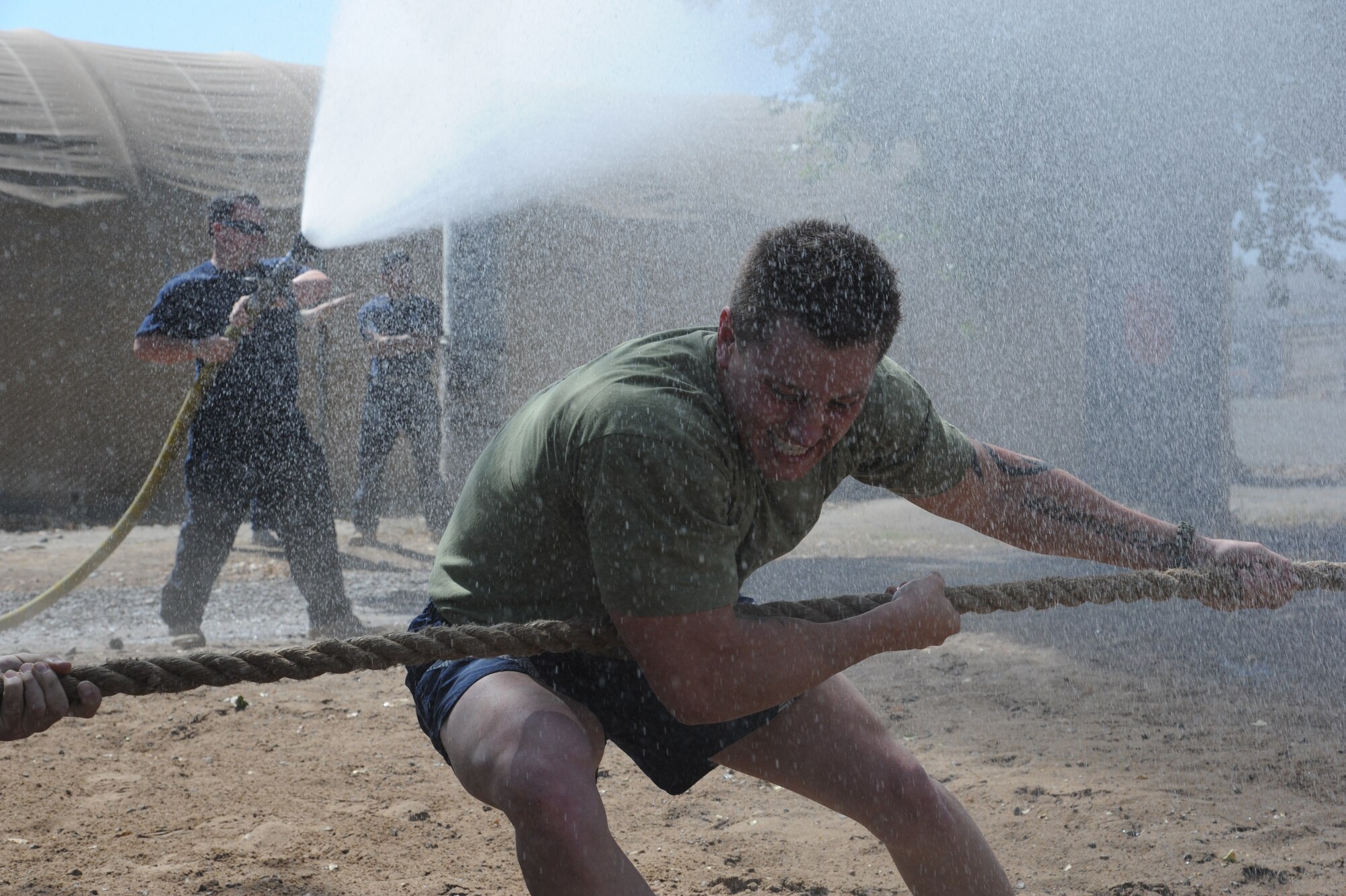 Staff Sgt. Brandon Knutson, 376th Expeditionary Maintenance Group structural repair specialist, pulls a rope with all his might during a tug of war event at the Transit Center at Manas, Kyrgyzstan, Sept. 10. The event was part of the Pete Ganci’s Inaugural First Responder’s Challenge, one of many 9/11 memorial events at the Transit Center. Knutson is deployed from the 141st Maintenance Squadron at Fairchild Air Force Base, Wash.   (U.S. Air Force photo/Tech. Sgt. Hank Hoegen)