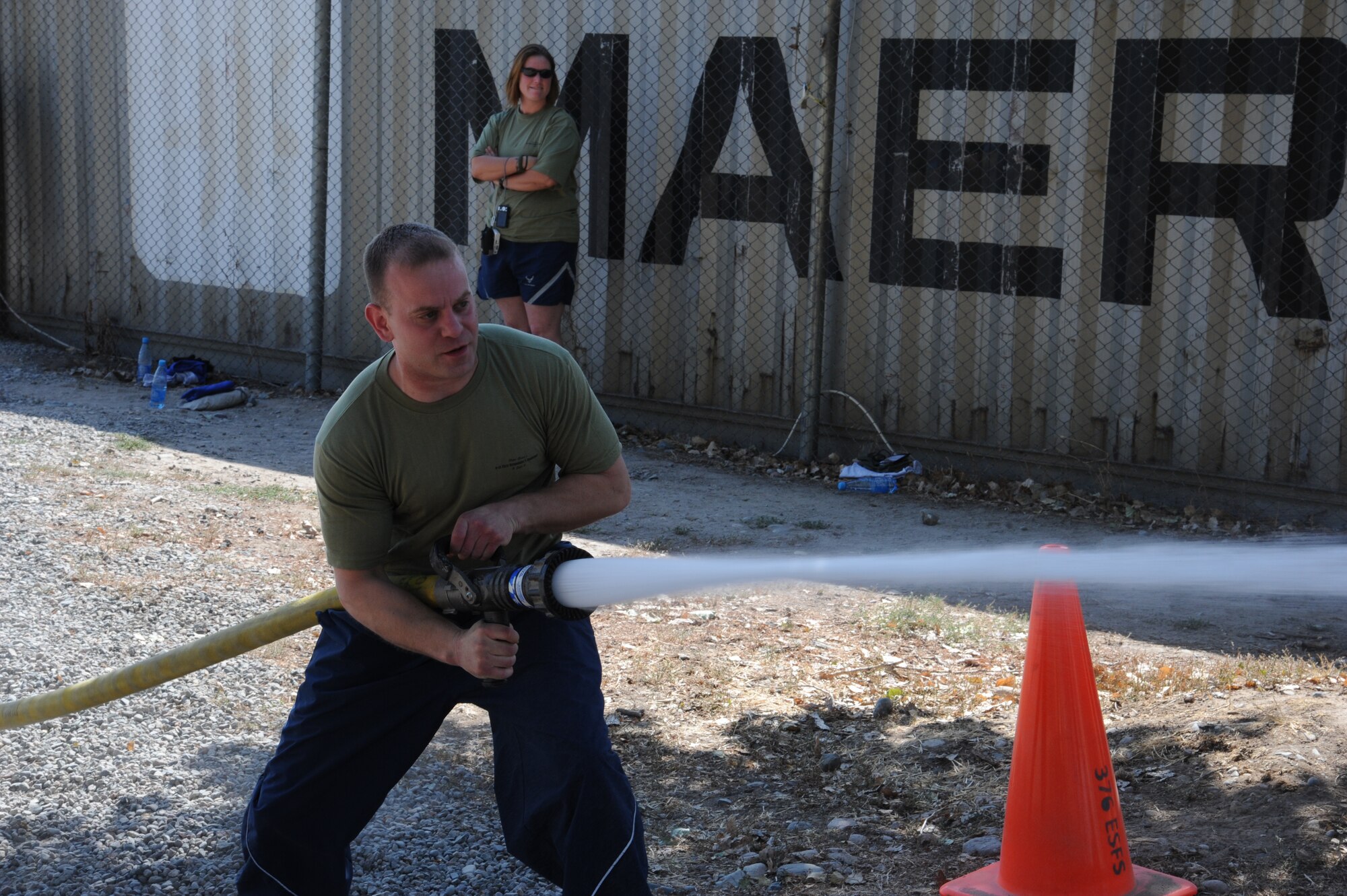 Airman 1st Class Daniel Fiuza, 376th Expeditionary Maintenance Group structural repair specialist, uses a firehose to knock down a target during a relay race at the Transit Center at Manas, Kyrgyzstan, Sept. 10. The race was part of the Pete Ganci’s Inaugural First Responder’s Challenge. The challenge was one of many 9/11 memorial events here. Most of the events were named after service members who were killed in action supporting Operations Iraqi and Enduring Freedom. Fiuza is deployed from the 92nd Maintenance Group at Fairchild Air Force Base, Wash. (U.S. Air Force photo/Tech. Sgt. Hank Hoegen)