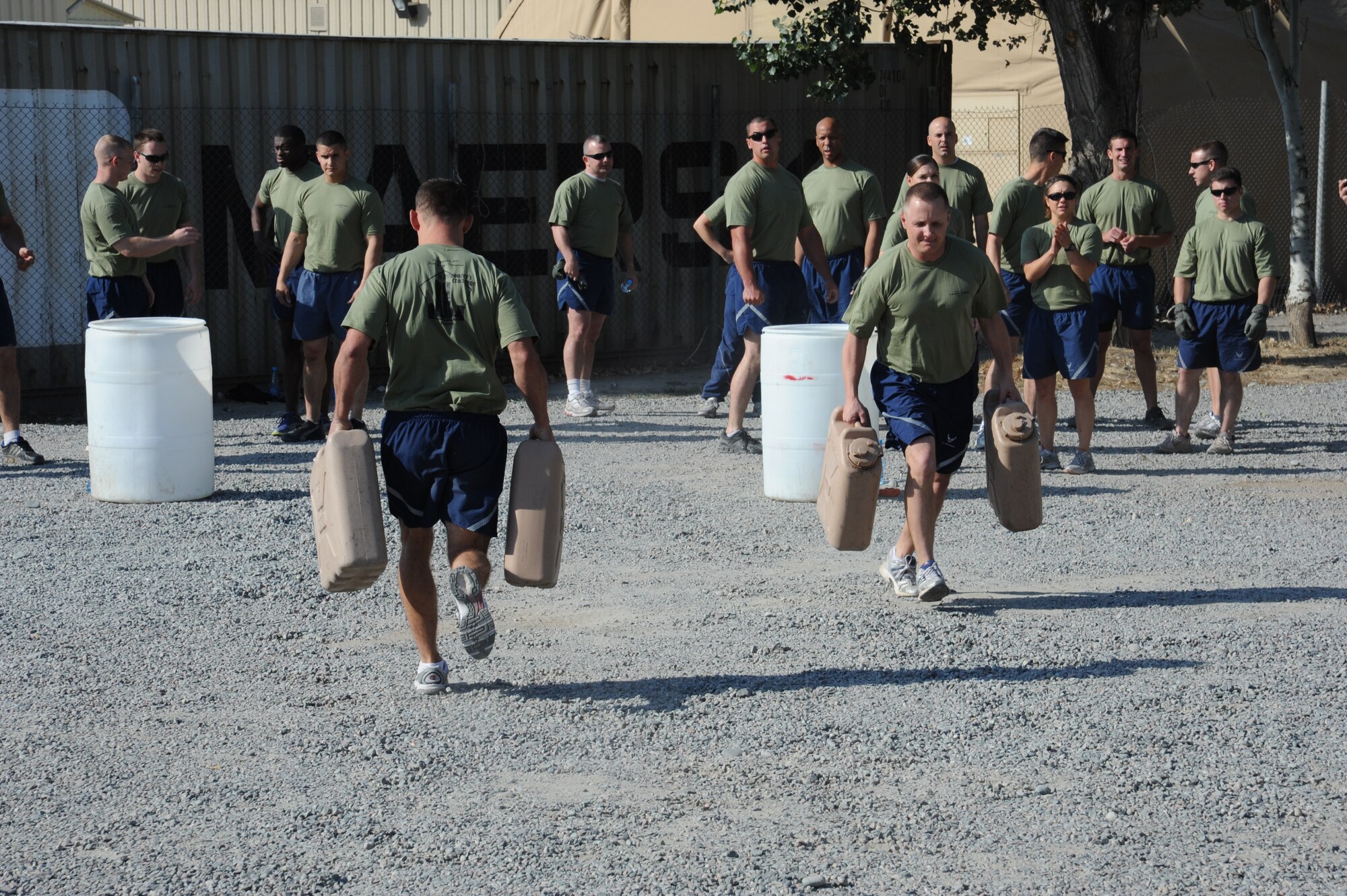 Senior Master Sgt. James Wadas, 376th Expeditionary Mission Support Group first sergeant, passes a competitor during a water jug relay race at the Transit Center at Manas, Kyrgyzstan, Sept. 10. The race was part of the Pete Ganci’s Inaugural 1st Responder’s Challenge. The challenge was one of many 9/11 memorial events here. Most of the events were named after service members who were killed in action supporting Operations Iraqi and Enduring Freedom. Wadas is deployed from the 17th Force Support Squadron at Goodfellow Air Force Base, Texas. (U.S. Air Force photo/Tech. Sgt. Hank Hoegen)