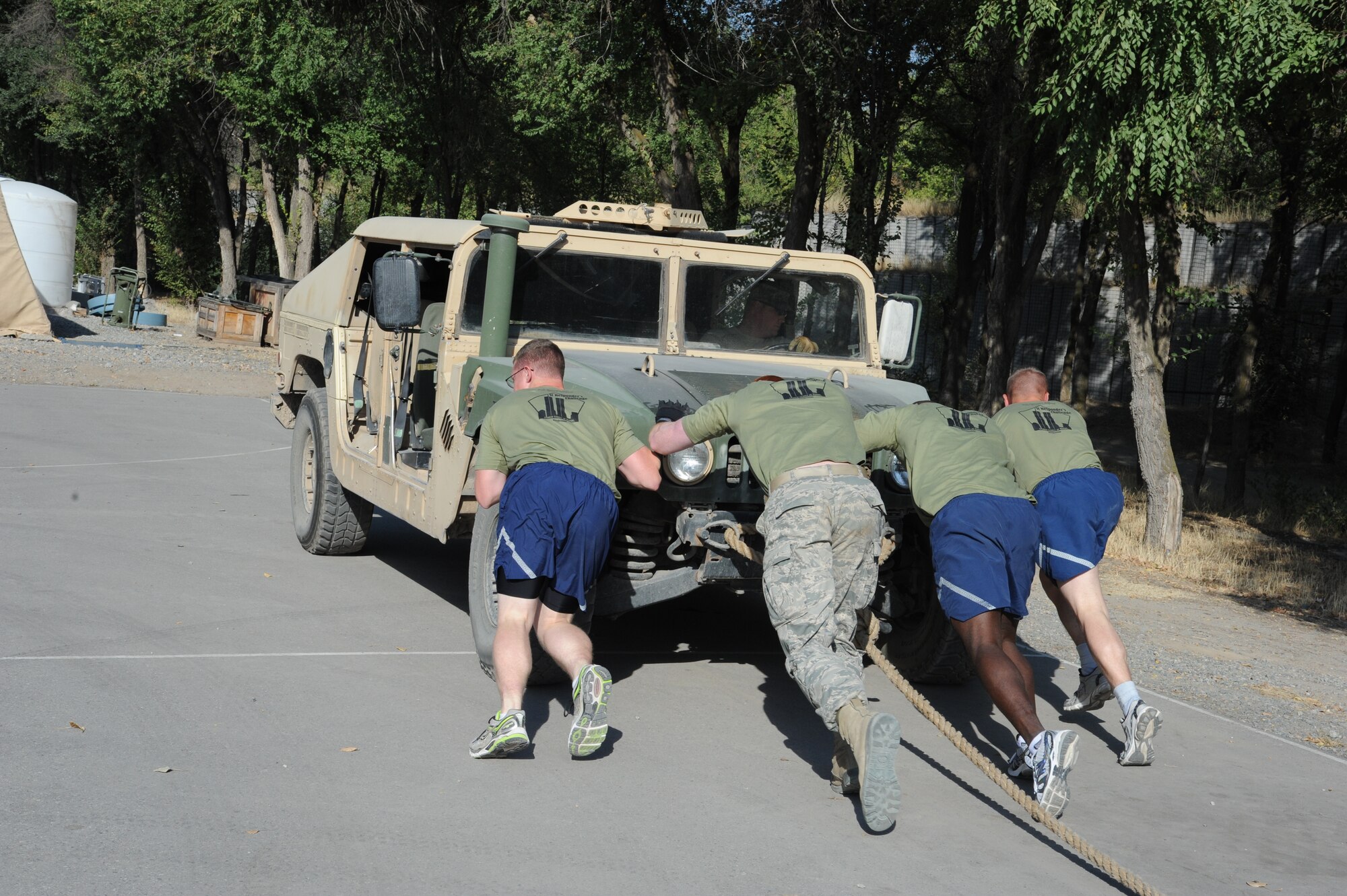 A group of Airmen push a Humvee during the Pete Ganci’s Inaugural First Responder’s Challenge at the Transit Center at Manas, Kyrgyzstan, Sept. 10. Participants had to pull, then push, the Humvee approximately 80 feet each way. The challenge was one of many 9/11 memorial events here. Most of the events were named after service members who were killed in action Supporting Operations Iraqi and Enduring Freedom. (U.S. Air Force photo/Tech. Sgt. Hank Hoegen)