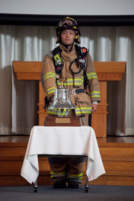 Hironaka Yoshihiro, a station firefighter, rings a bell during the bell ceremony at the Marine Memorial Chapel here Sunday in remembrance of those lost during the September 11, 2001, terrorist attacks. Marine Corps Community Services hosted the Sept. 11 Freedom Walk and 10th anniversary remembrance ceremony.