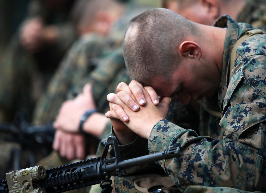 Pfc. Eric Gonzales, a rifleman with 1st Platoon, Bravo Company, 1st Battalion, 2nd Marine Regiment, bows his head during a moment of silence in remembrance of the terrorist attacks of Sept. 11, 2001, on Fort Pickett Va., Sep. 11, 2011. More than 900 Marines and Sailors will take part in the Deployment for Training exercise at Fort Pickett, Sept. 6-23. The battalion is scheduled to attach to the 24th Marine Expeditionary Unit a few days after the training.