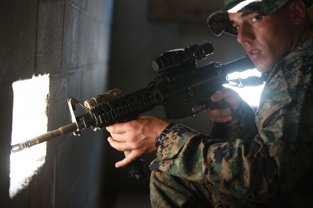 Seaman Marcus Fluke, a hospital corpsman with Bravo Company, 1st Battalion, 2nd Marine Regiment, scans over his sights while posting security during Military Operations in Urban Terrain training at the Urban Assault Course on Fort Pickett, Va., Sep. 11, 2011. More than 900 Marines and sailors will take part in the Deployment for Training exercise at Fort Pickett, Sept. 6-23. The battalion is scheduled to attach to the 24th Marine Expeditionary Unit a few days after the training.