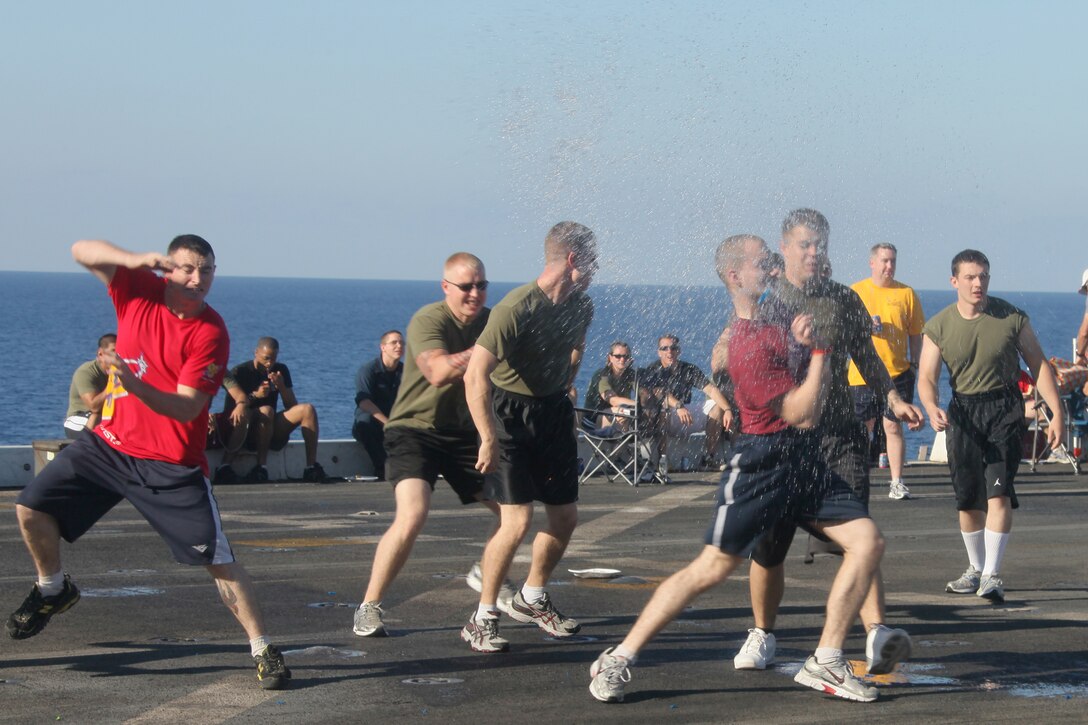 Marines participate in a water balloon dodge-ball competition during a steel beach aboard amphibious transport dock USS Mesa Verde (LPD-19), Sept. 11, 2011.  The Mesa Verde held the steel beach for unit cohesion and to boost the morale of the embarked Marines and sailors. The Marines and sailors of the 22nd MEU are currently deployed with Amphibious Squadron 6 (PHIBRON 6) aboard the USS Bataan Amphibious Ready Group (BATARG) and will continue to train and improve the MEU’s ability to operate as a cohesive and effective Marine Air Ground Task Force.  The 22nd MEU is a multi-mission, capable force, comprised of an Aviation Combat Element, Marine Medium Tilt Rotor Squadron 263 (Reinforced)(VMM-263 (REIN)); a Logistics Combat Element, Combat Logistics Battalion 22(CLB 22); a Ground Combat Element, Battalion Landing Team, 2nd Battalion, 2nd Marine Regiment(BLT 2/2) and its Command Element.
