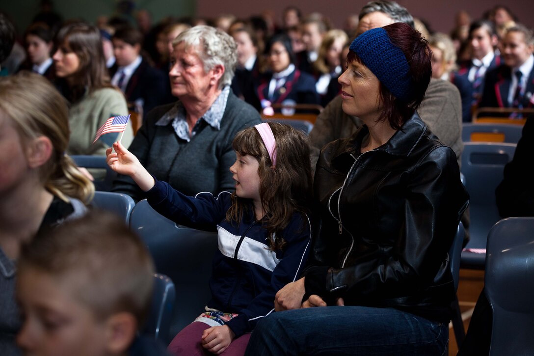 A young girl from New Zealand waves an American flag as the U.S. Marine Corps Forces, Pacific Band performs at the Stratford War Memorial Centre here Sept. 13. The concert was held for the Stratford community to celebrate the 70th anniversary of Marines landing in Wellington in 1942. (Official U.S. Marine Corps photo by Lance Cpl. Isis M. Ramirez)