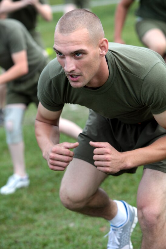 Cpl. Corey Nicolini, motor transportation operator, motor transportation platoon, Headquarters Battery, 10th Marines, 2nd Marine Division, does knee strikes as part of a high intensity work-out during the 9/11 Memorial Physical Training session conducted aboard the Marine Corps Base Camp Lejeune N.C., Sept. 12. Following the Memorial PT session the Marines were gathered together and asked to share their personal testimonials of the 9/11 attacks.