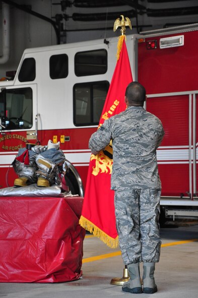 Senior Airman Michael Serna, 51st Civil Engineer Squadron firefighter, adjusts the Osan Fire Department flag Sept. 11, 2011 at Osan Air Base, Republic of Korea. “We will never forget,” is a phrase many Americans have heard thousands of times since Sept. 11, 2001, but for some the words go a bit deeper. The 51st CES fire department held a ceremony to remember and honor the firefighters who lost their lives that fateful day. (U.S. Air Force photo/Tech. Sgt. Chad Thompson)