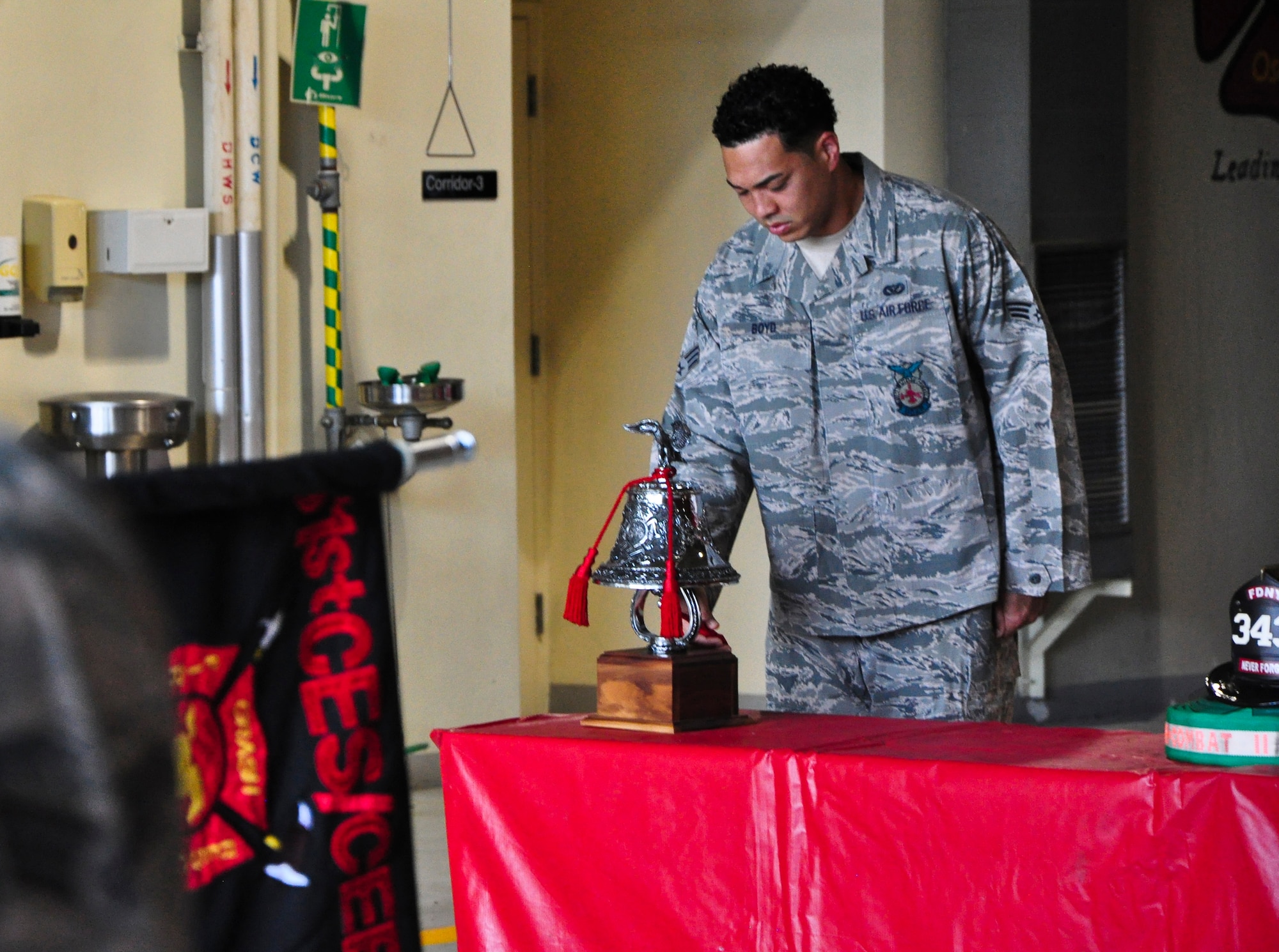 Senior Airman Larry Boyd, 51st Civil Engineer Squadron firefighter, rings a bell during the "Striking Four Fives" ceremony Sept. 11, 2011 at Osan Air Base, Republic of Korea. “We will never forget,” is a phrase many Americans have heard thousands of times since Sept. 11, 2001, but for some the words go a bit deeper. The 51st CES fire department held a ceremony to remember and honor the firefighters who lost their lives that fateful day. (U.S. Air Force photo/Tech. Sgt. Chad Thompson)