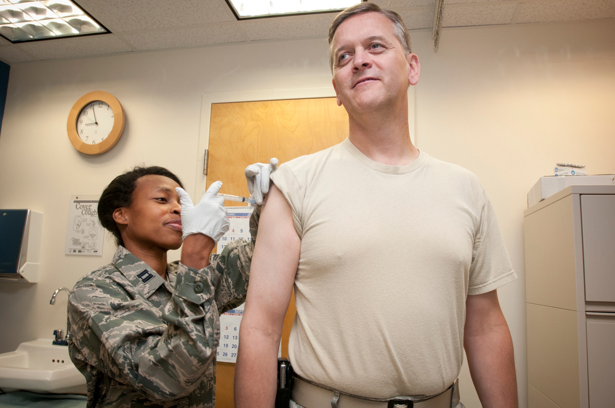 JOINT BASE ANDREWS, Md. -- Col. Russell A. Muncy, 459th Air Refueling Wing commander, receives his flu shot from Capt. Joan Sparrock, 459th Aerospace Medicine Squadron officer in charge of immunizations here Sept. 10. The flu shot and flu mist was being administered by the 459th AMDS during the September Unit Training Assembly and will be provided during the October UTA as well. (U.S. Air Force photo/Tech Sgt. Steve Lewis)