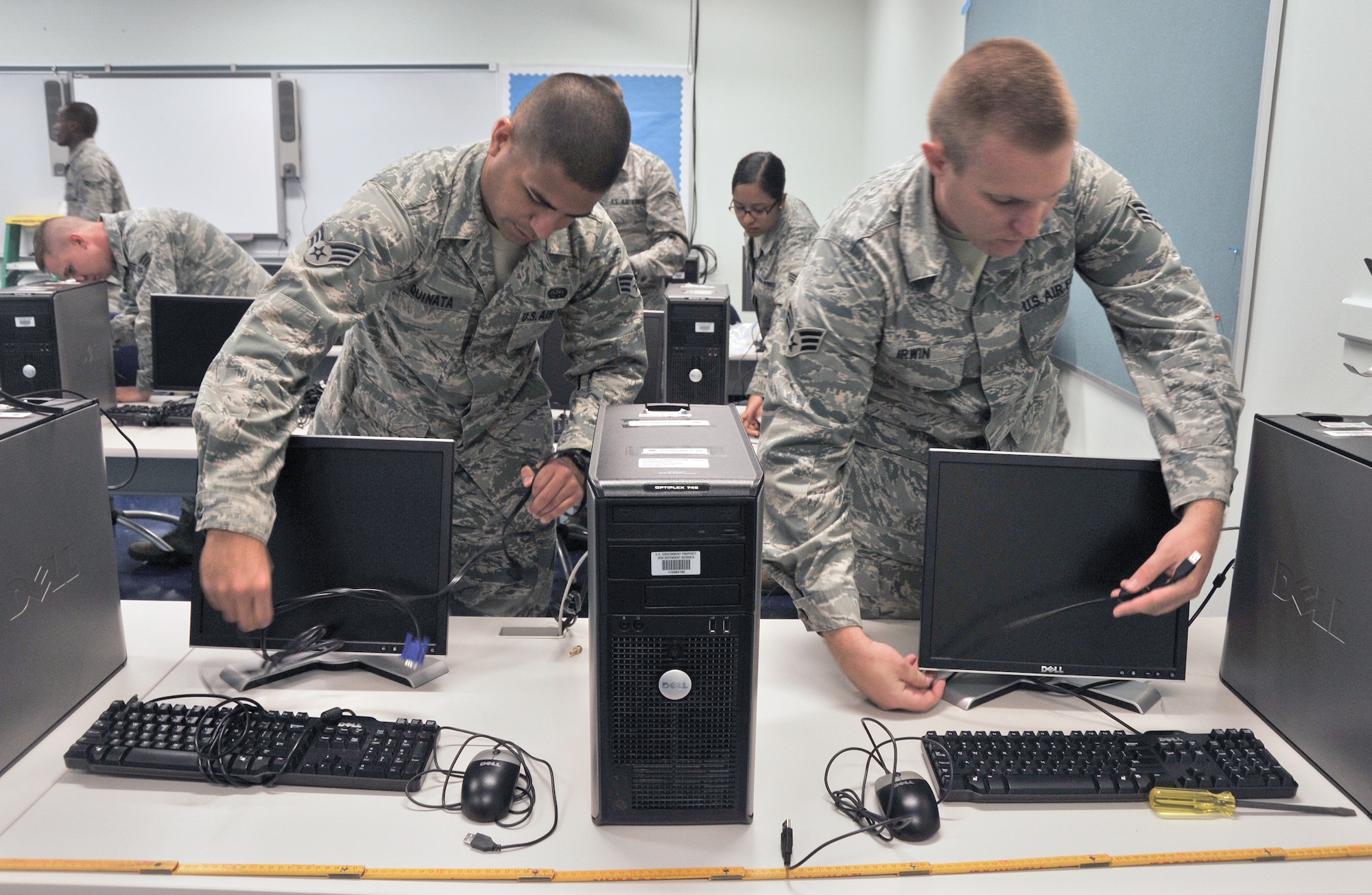 ANDERSEN AFB, Guam—Airmen from the 644th Combat Communication Squadron set up a computer lab in the elementary school here Sept. 9. Volunteers from the 644 CBCS visited the Andersen Elementary School to setup a new computer lab and Smart Boards for students. (U.S. Air Force photo by Staff Sgt. Alexandre Montes)