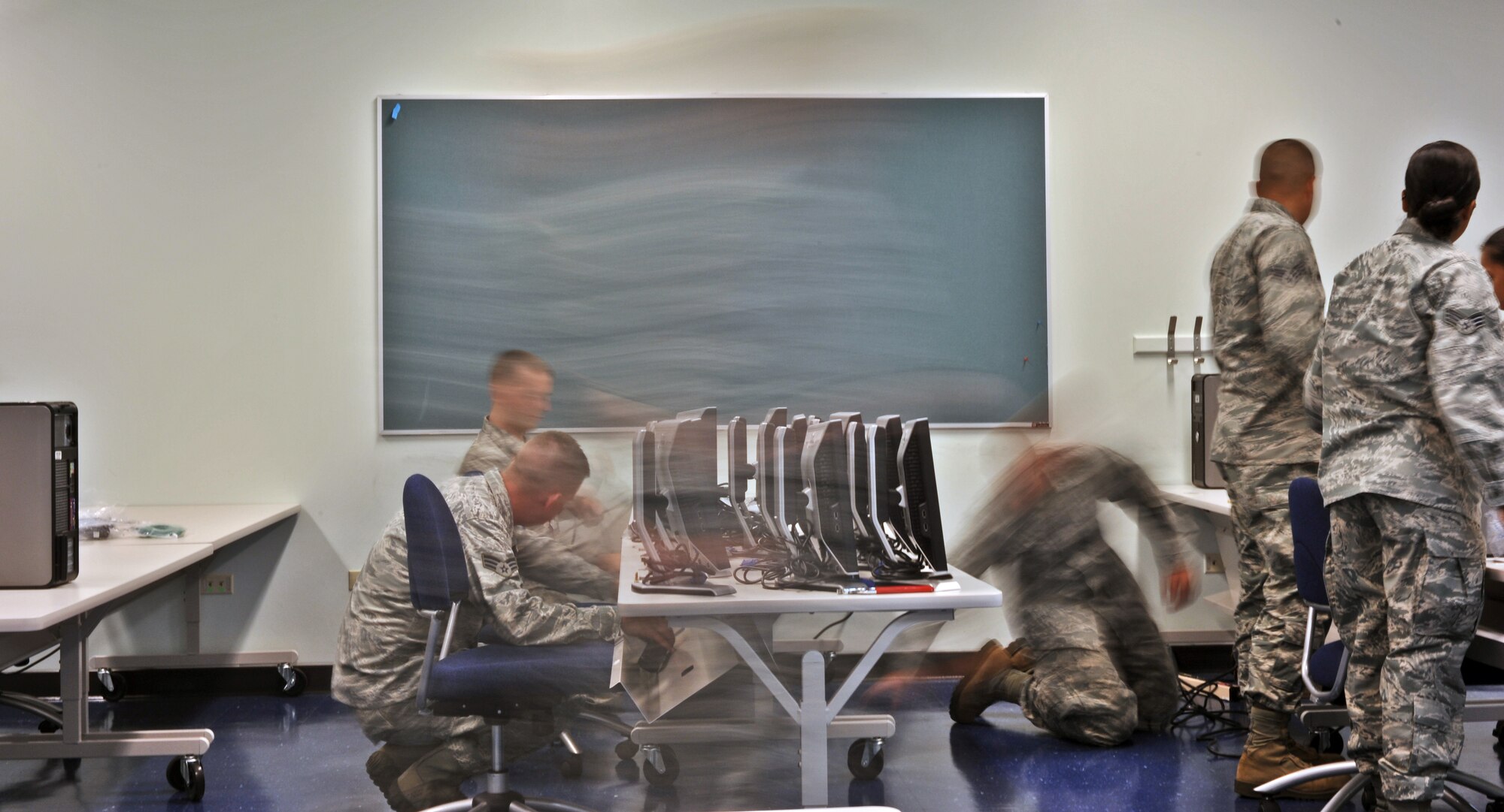 ANDERSEN AFB, Guam—Airmen from the 644th Combat Communication Squadron set up a computer lab in the elementary school here Sept. 9. Volunteers from the 644 CBCS visited the Andersen Elementary School to setup a new computer lab and Smart Boards for students. (U.S. Air Force photo by Staff Sgt. Alexandre Montes)