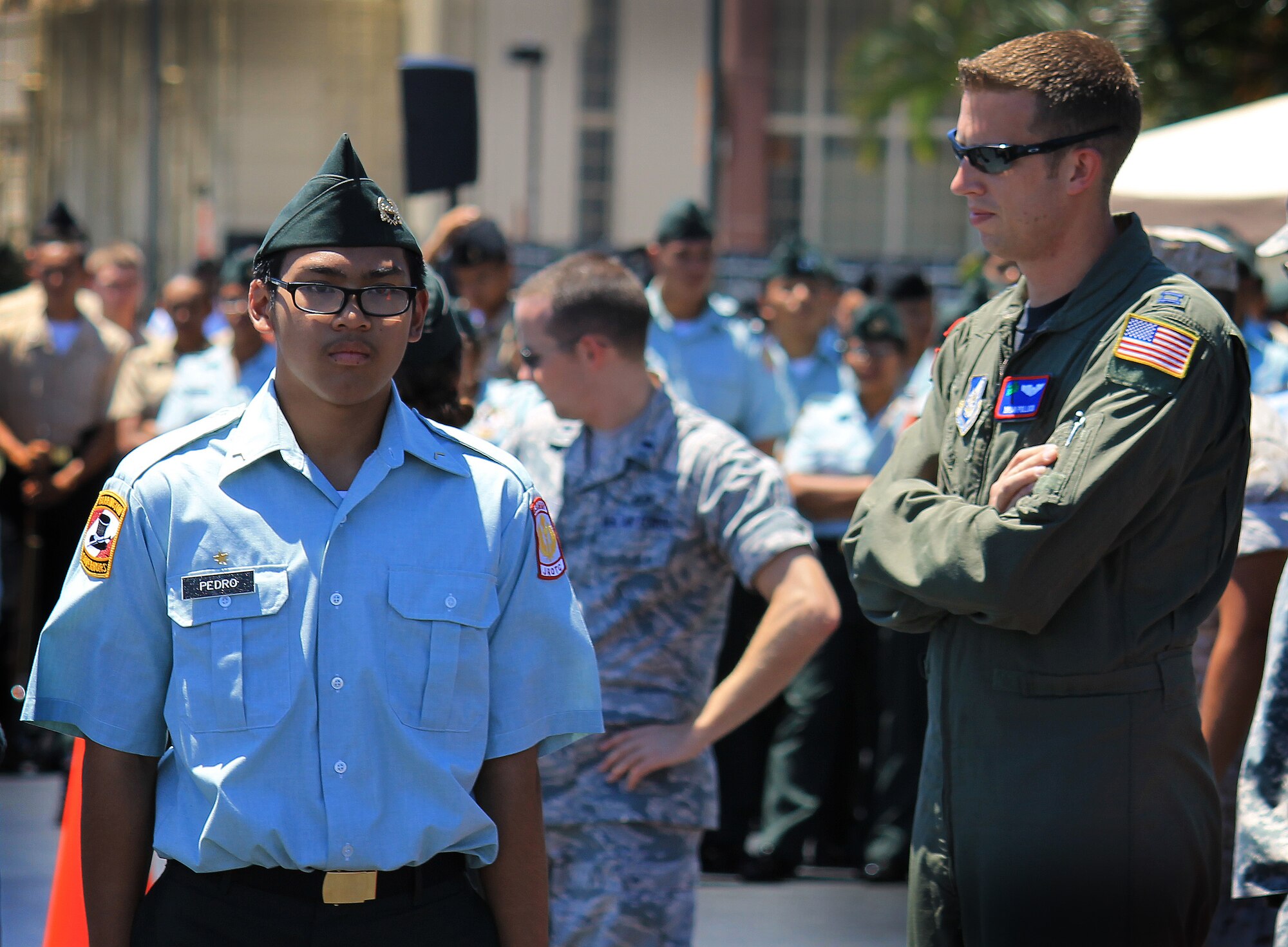 An Army Junior Reserve Officer's Training Corps cadet is inspected by Capt. Brian Pollock, 15th Operations Support Squadron C-17 pilot, at the annual drill competition held on the Hickam Field flightline, Sept. 10. More than 300 JROTC cadets, from more than 14 high schools on Oahu attended the event. (U.S. Air Force photo/Senior Airman Lauren Main)