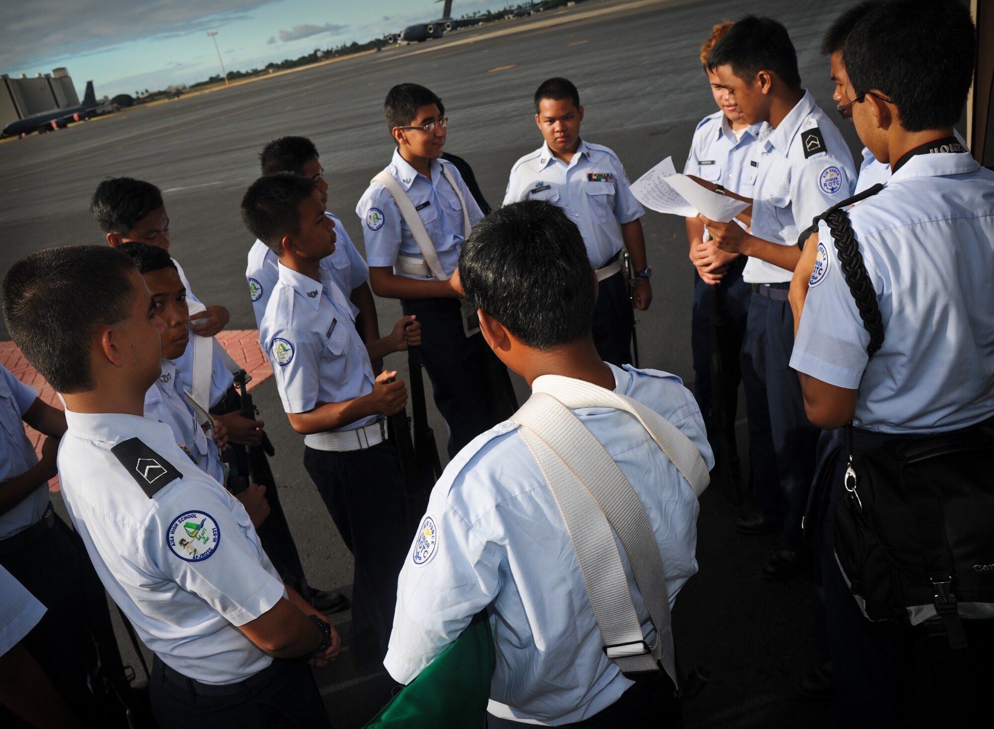 Junior Reserve Officer's Training Corps cadets from Aiea High School gather to discuss the days events at the annual drill competition held on the Hickam Field flightline, Sept. 10. More than 300 JROTC cadets attended the event. (U.S. Air Force photo/Senior Airman Lauren Main)